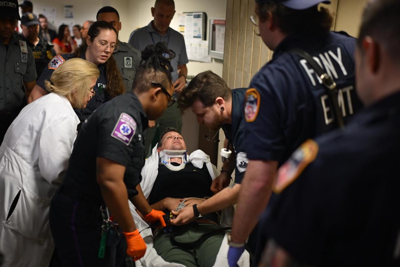 Anadolu Agency chief cameraman Vural Elibol is being taken to hospital after falling and hitting his head on ground following intervention by ICE officers, New York, Sept. 30, 2025. (AA Photo)