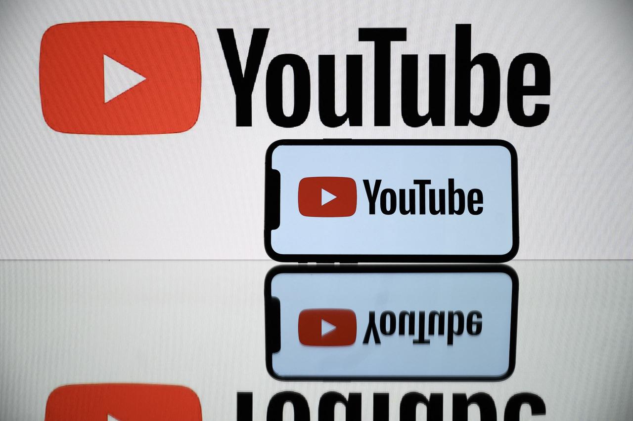 A picture taken on October 5, 2021 in Toulouse shows the logo of Youtube social media displayed by a by a tablet and a smartphone. (AFP Photo)