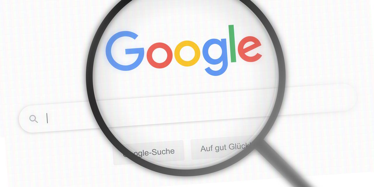 Google, the world's most popular search engine, has its homepage on the screen under a magnifying glass. Paris, France, October 19, 2017. (Adope stock Photo )
