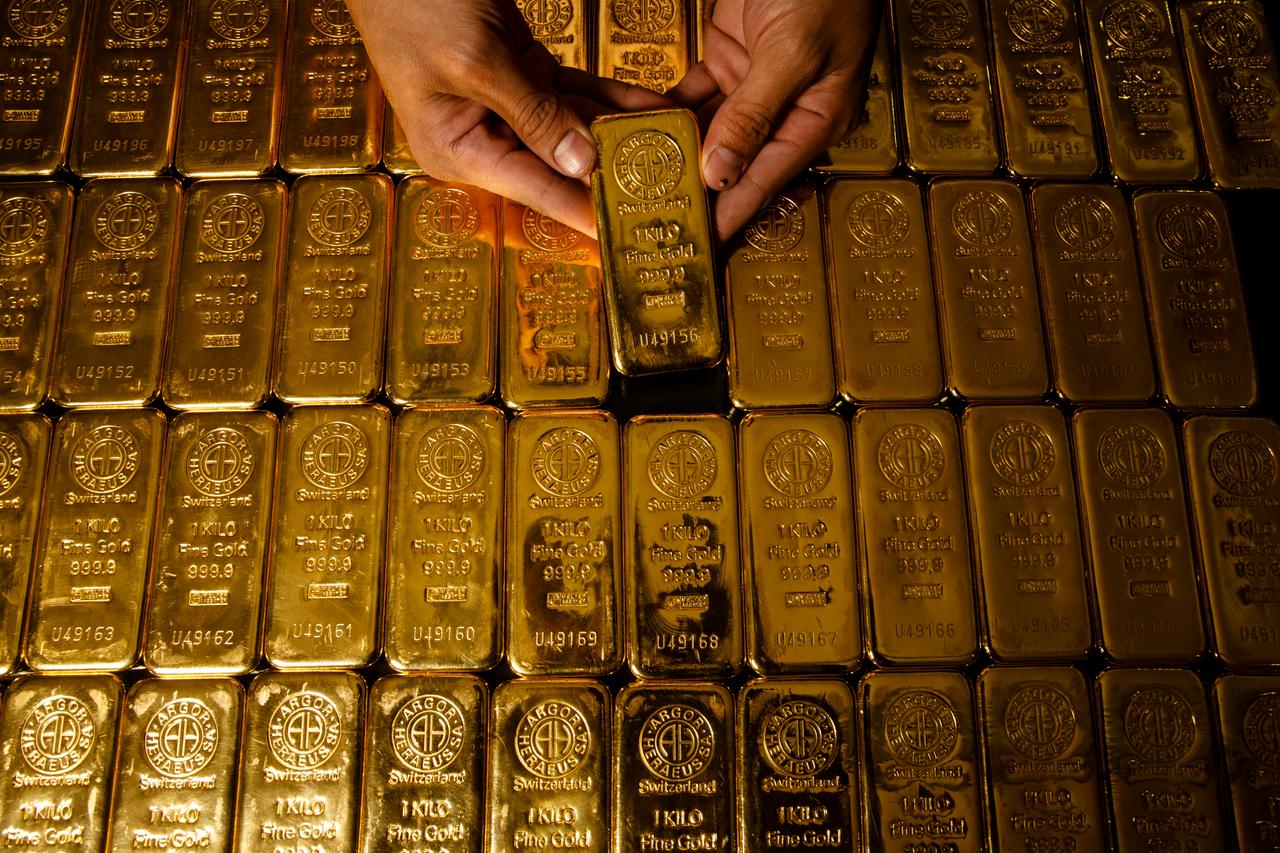 File photo shows stacks of one-kilogram gold bars displayed at a vault. (Adobe Stock Photo)