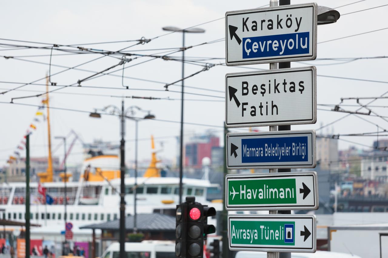 Traffic signs direct drivers toward Karakoy, Besiktas, Fatih, the Eurasia Tunnel, and the airport in central Istanbul, Türkiye. (Adobe Stock Photo)