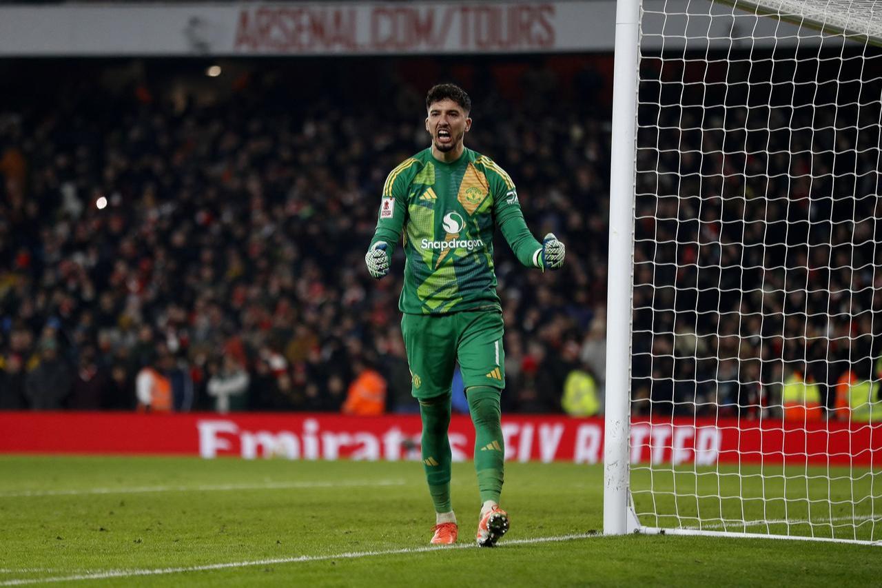 Manchester United's Turkish goalkeeper #01 Altay Bayindir reacts after saving the penalty during the English FA Cup third round football match between Arsenal and Manchester United at the Emirates Stadium in London, January 12, 2025. (AFP Photo)
