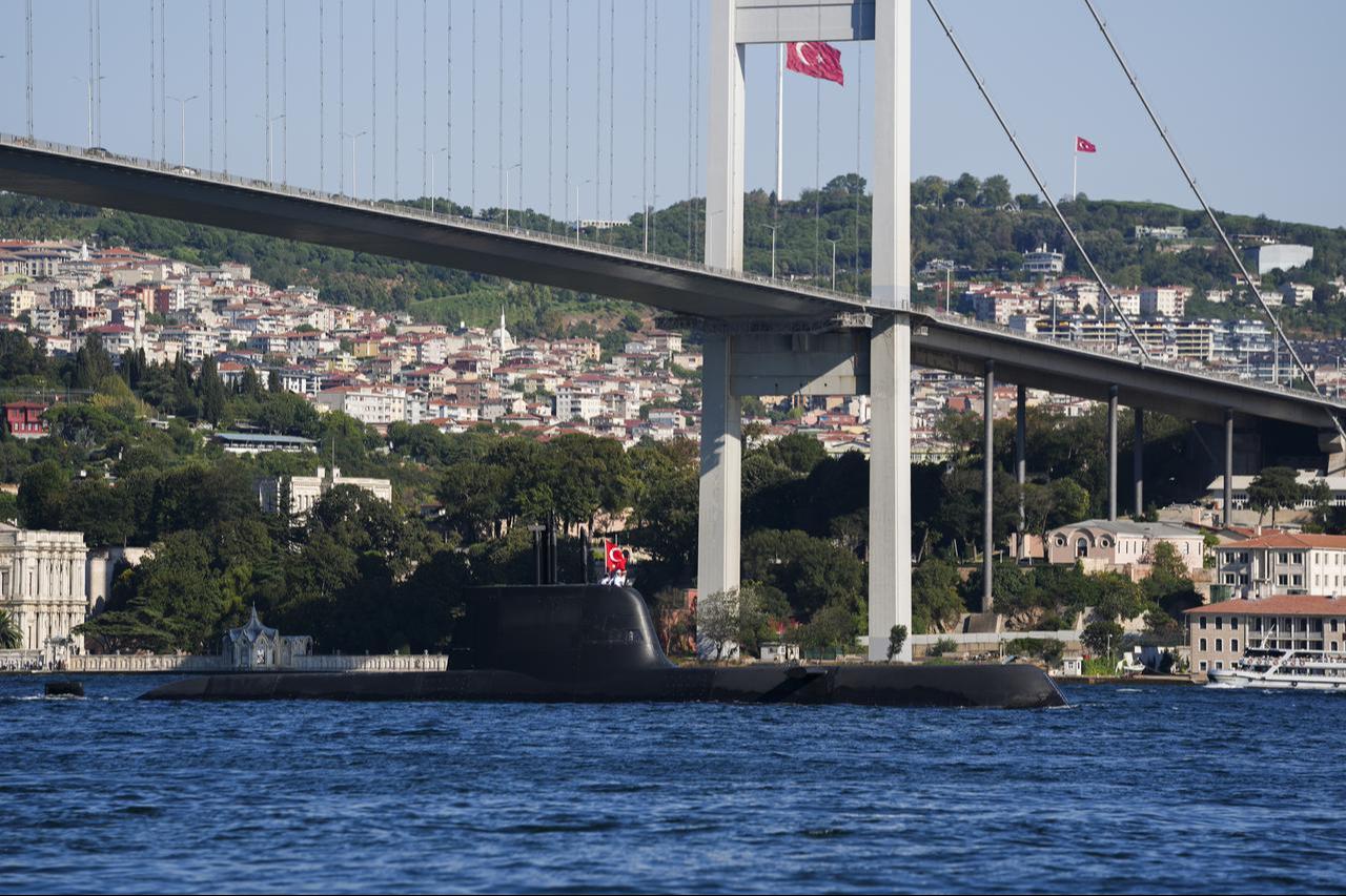 A view of TCG Hizirreis sailing alongside Ortakoy Mosque and Bosporus Bridge during a parade in the Bosphorus, in Istanbul, Türkiye, August 24, 2025. (AA Photo)