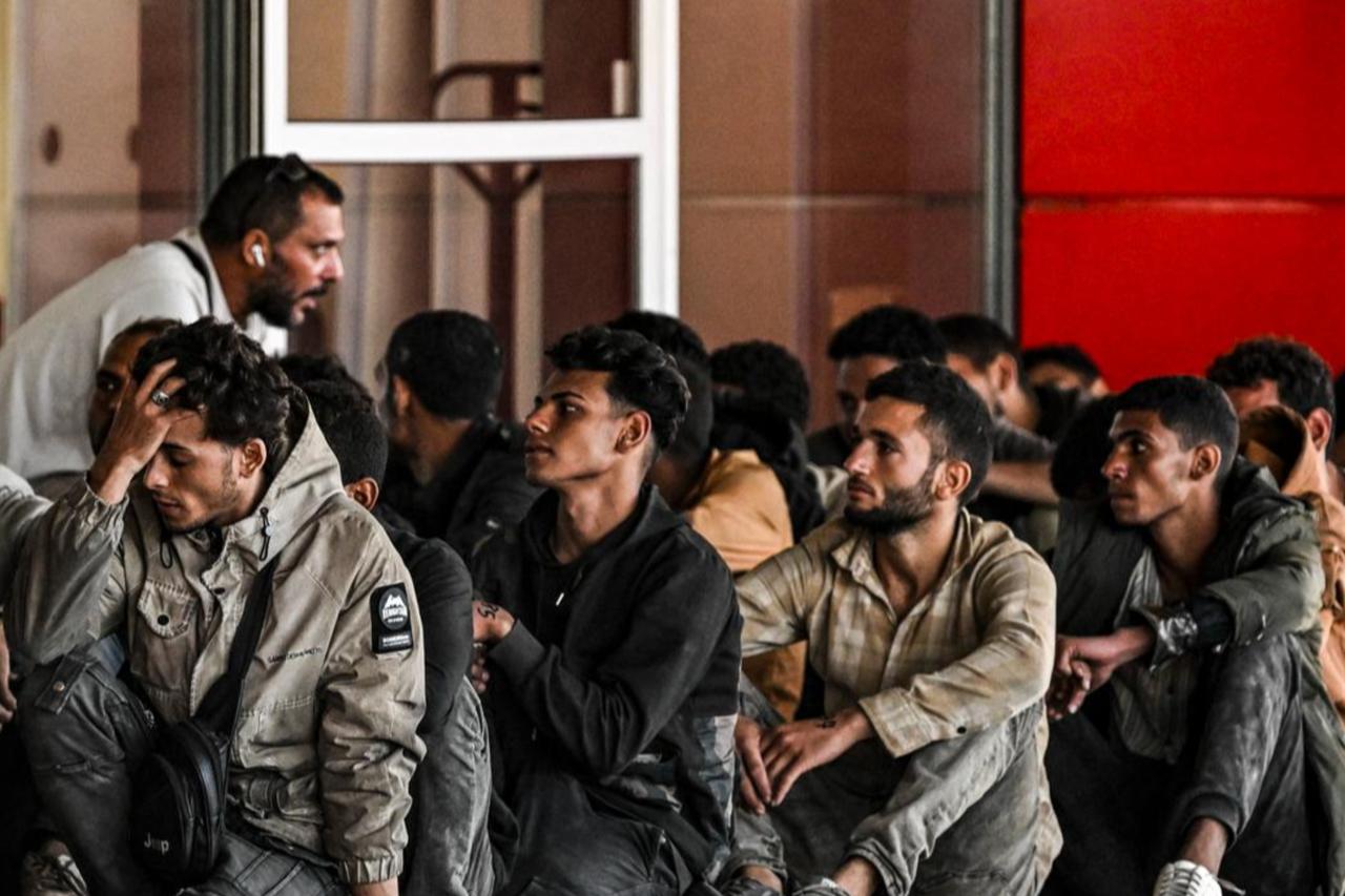 Greek coast guard officers gather migrants who have just arrived by cargo ship at the port of Lavrio, located south of Athens, Greece, July 10, 2025. (AFP Photo)