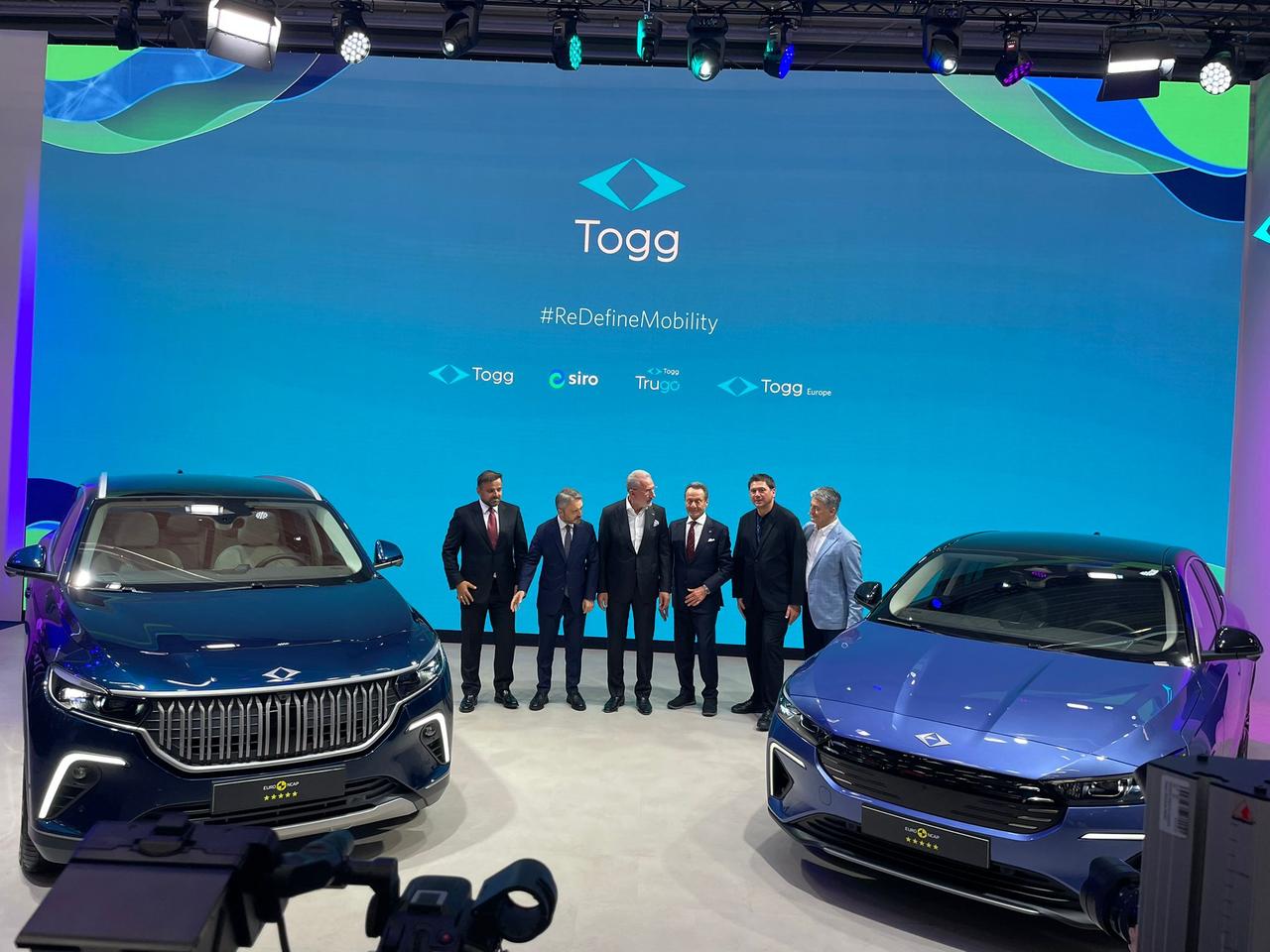 Executives pose with Togg’s T10X and T10F models during the company’s presentation at IAA Mobility 2025 fair in Munich, Germany, Sept. 8, 2025. (Photo via turkiyegazetesi.com.tr)