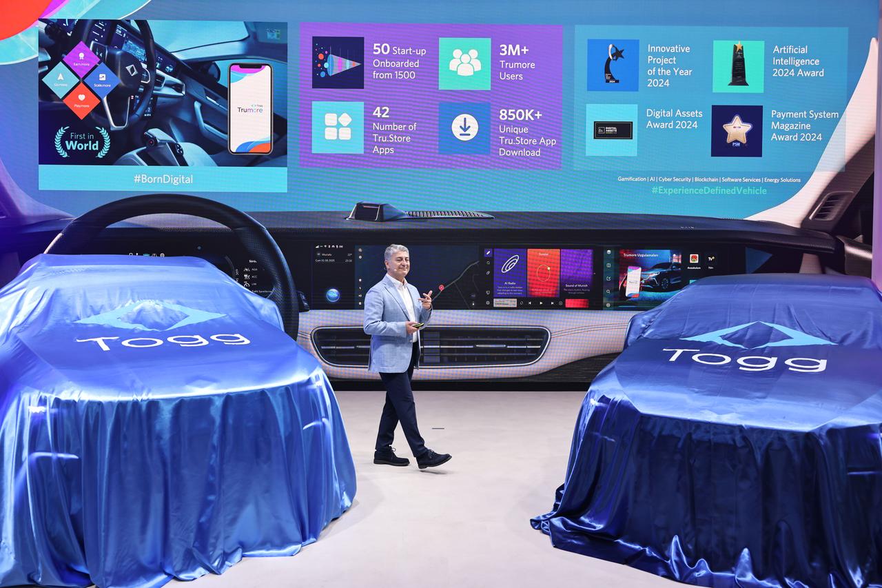 Togg CEO M. Gurcan Karakas presents the company’s digital ecosystem and Trumore platform during a vehicle showcase at the IAA Mobility 2025 fair in Munich, Germany, Sept. 8, 2025. (Courtesy of Togg)