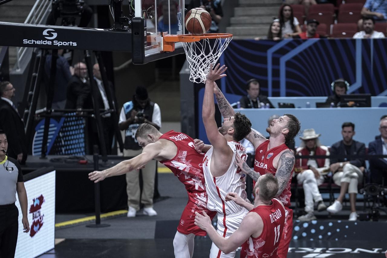 Alperen Sengun (2nd L) of Türkiye in action against Aleksander Balcerowski (R) of Poland during the FIBA EuroBasket 2025 quarterfinal match between Türkiye and Poland at Arena Riga in Riga, Latvia, on Sep. 9, 2025. (AA Photo)