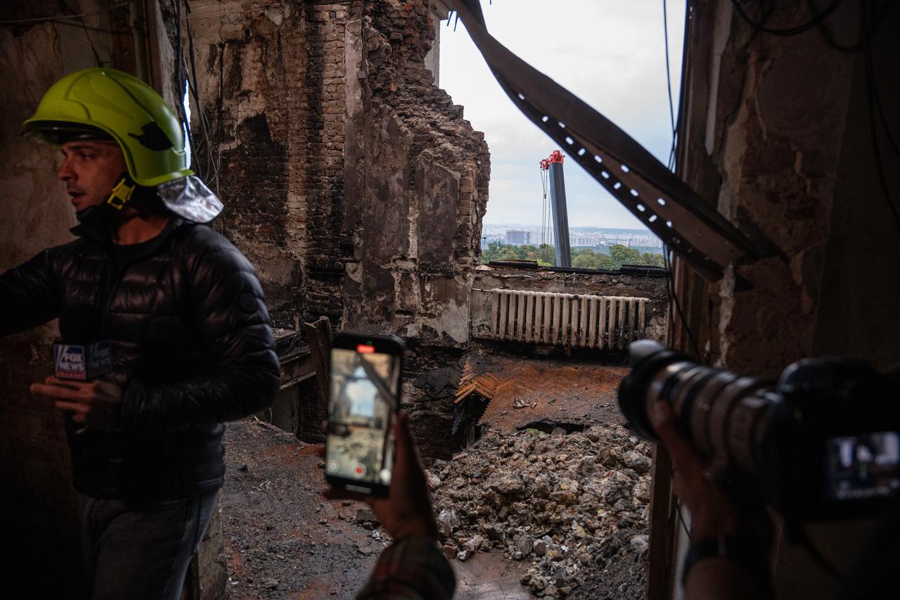 Journalists work inside a headquarters of Ukrainian government that was hit by a Russian “Iskander-K” cruise missile on September 7 during an overnight Russian attack in Kyiv, Ukraine, on September 8, 2025. (AA Photo)