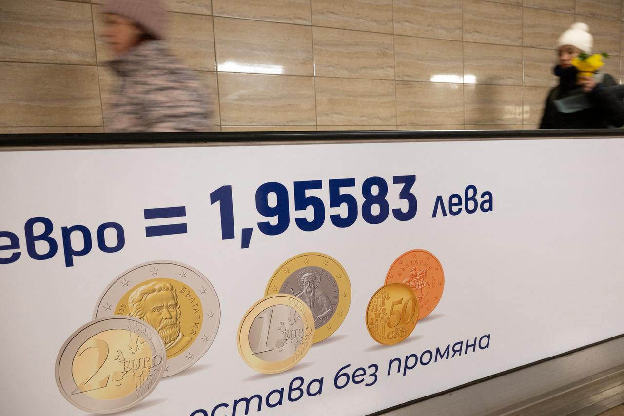 Commuters walk along a moving walkway in Sofia's subway beside an advertisement promoting Bulgaria's entry into the Eurozone on December 31, 2025. (AFP Photo)