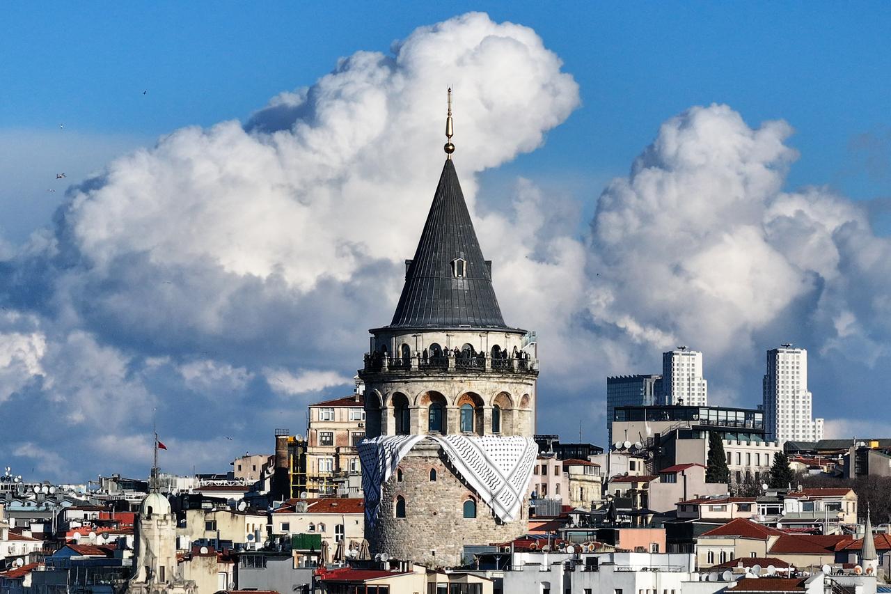 A view of Galata Tower is seen after a Palestinian keffiyeh was hung on for the mass pro-Palestinian march on Galata Bridge in Istanbul, Türkiye on January 1, 2026. (AA Photo)