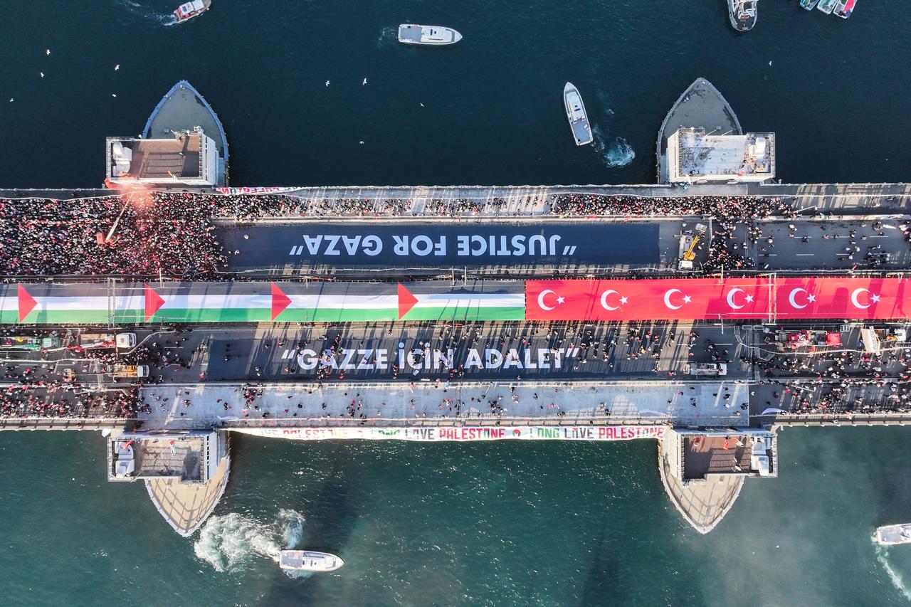 An aerial view of Galata Bridge as thousands of people have gathered across Istanbul to march in solidarity with Palestinians, calling for an end to war on Gaza, on Jan. 1, 2026. (AA Photo)