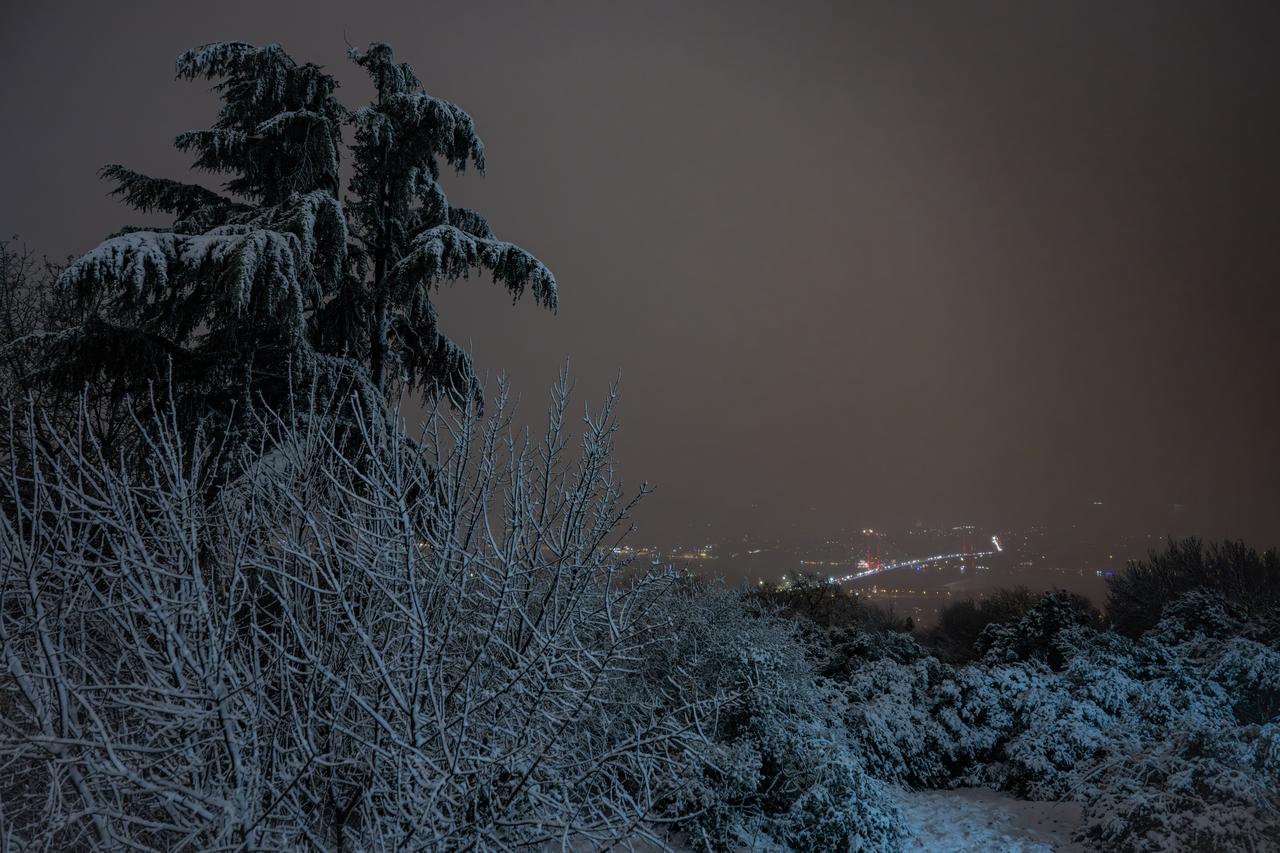 People walk at Camlica Hill during snowfall in Istanbul, Türkiye on Dec. 31, 2025. (AA Photo)