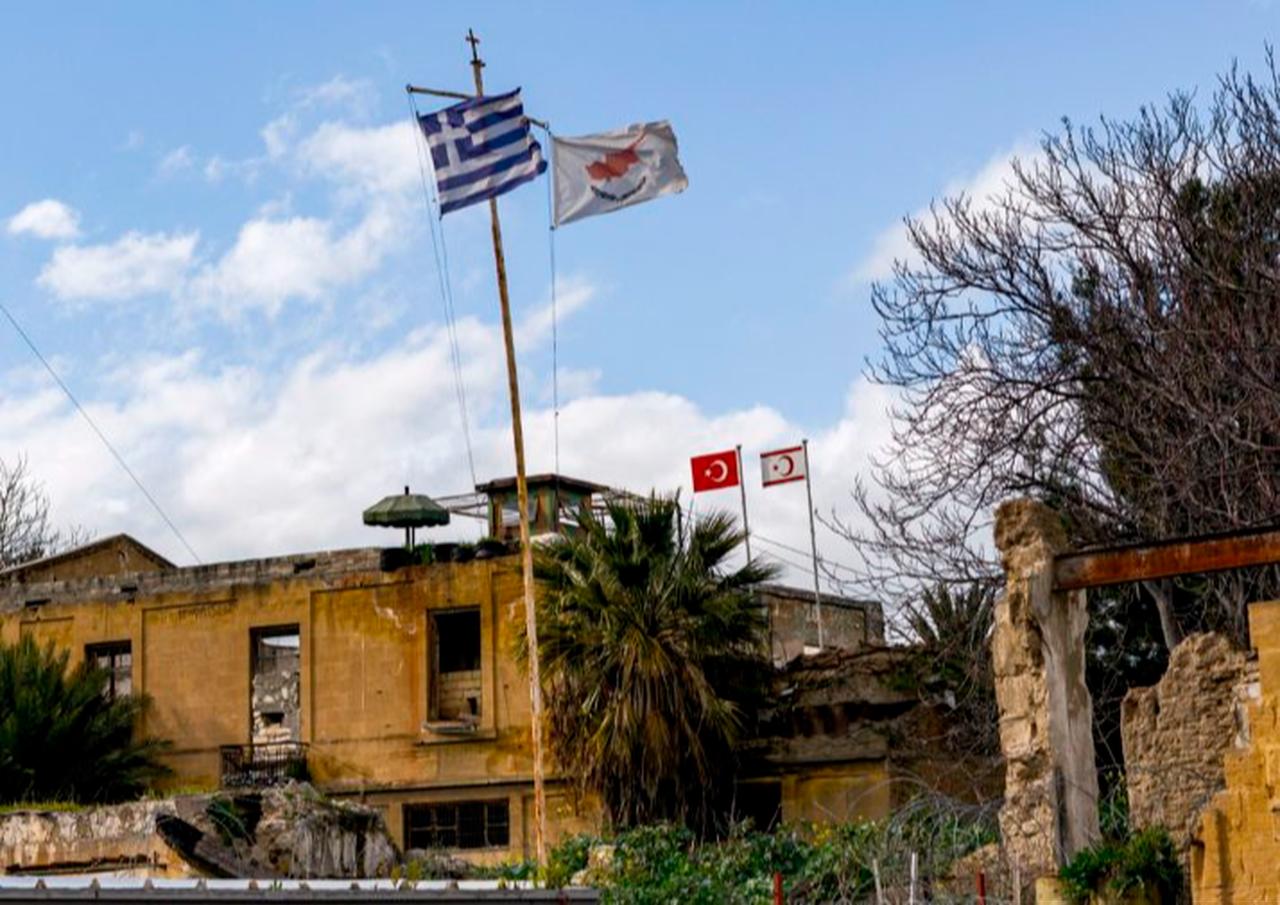 A view of (L to R, foreground) the flags of Greece, Greek Cyprus, (L to R, background) Türkiye, and Turkish Republic of Northern Cyprus (TRNC) flying on respective security outposts lying off both sides of the UN Buffer Zone, Nicosia, Feb. 7, 2020. (AFP Photo)