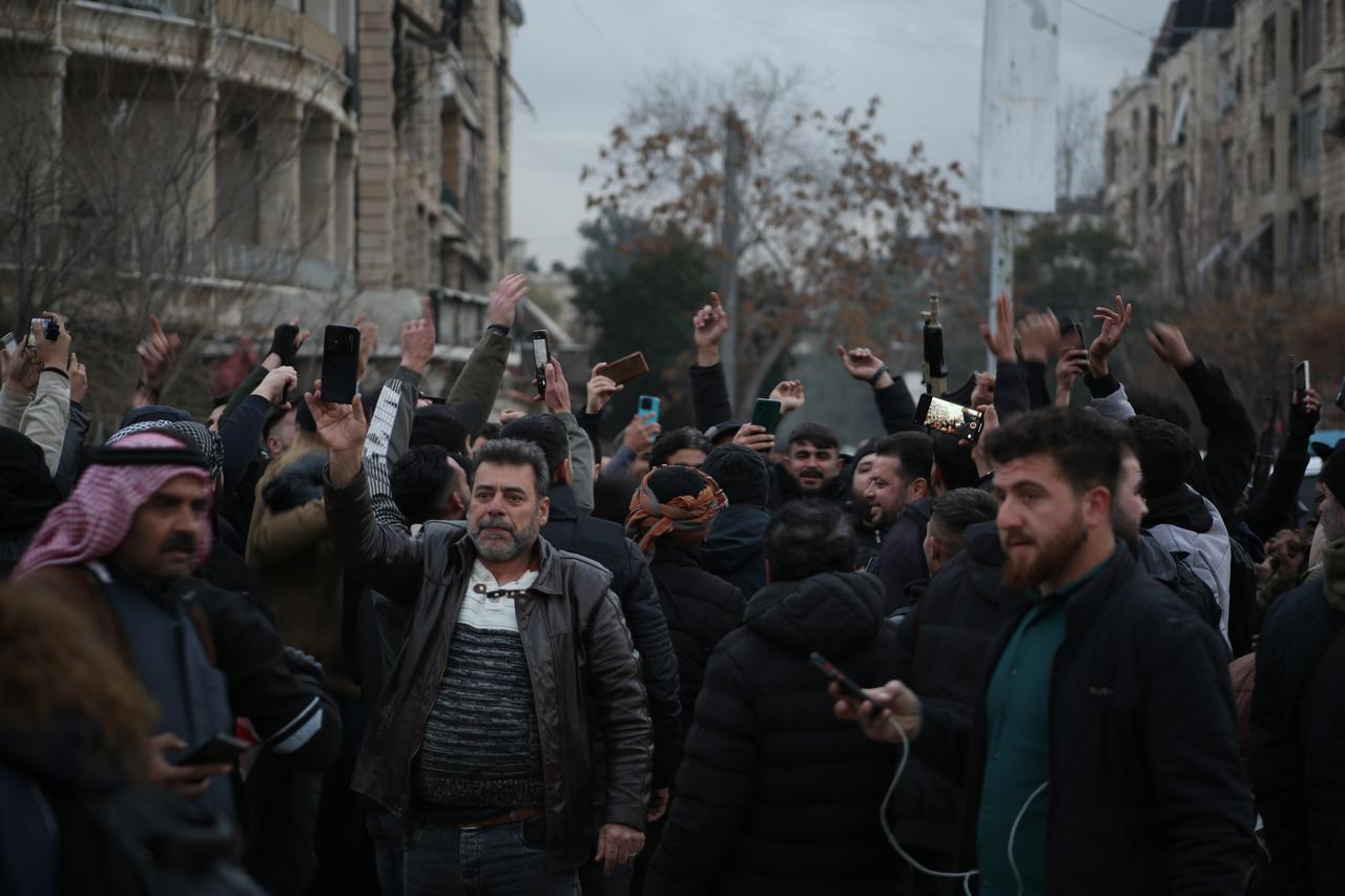 Syrians celebrate after all members of YPG terrorist organization, operating under the name SDF are evacuated out of Aleppo to Tabqah by bus, in Aleppo, Syria on Jan. 10, 2026. (AA Photo)