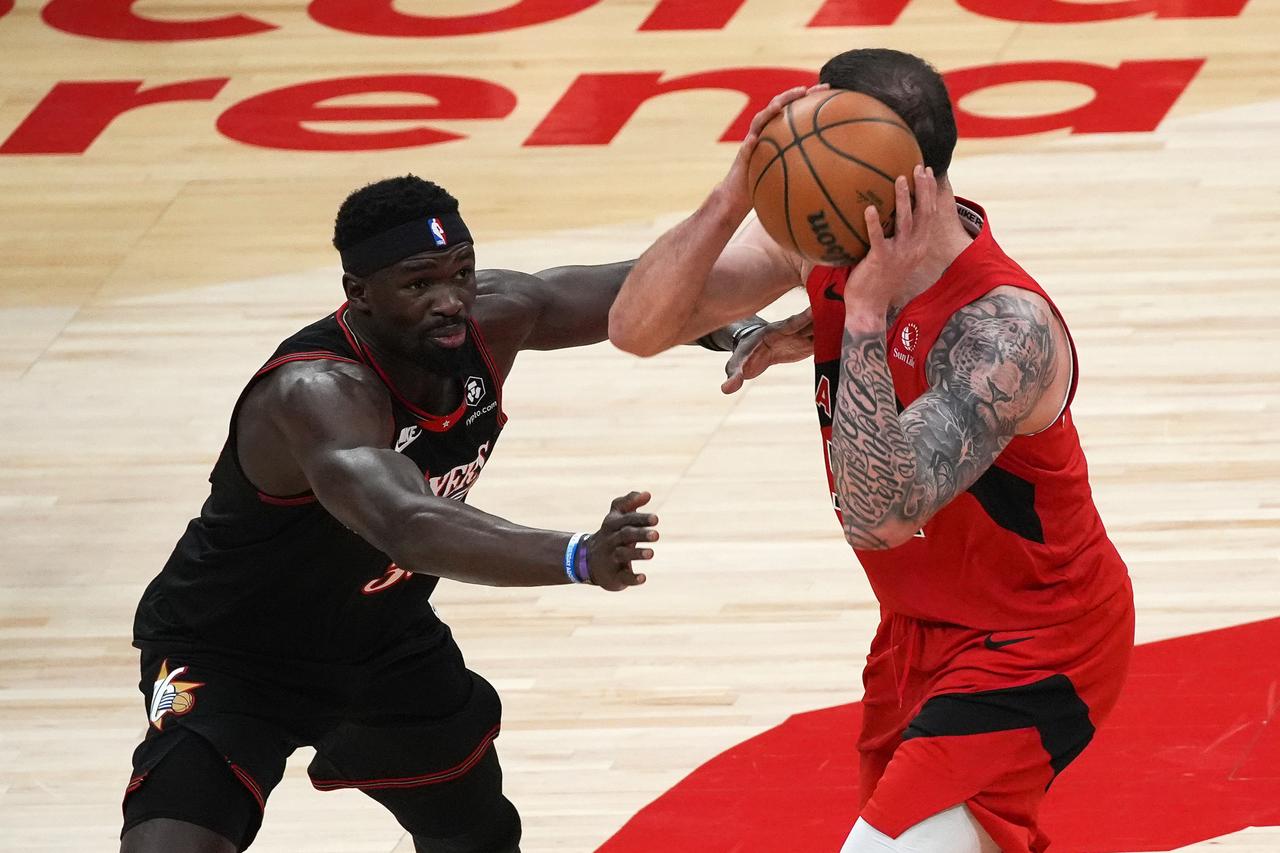 Adem Bona (30) of Philadelphia 76ers in action against Sandro Mamukelashvili (54) of Toronto Raptors during the NBA basketball game between Philadelphia 76ers and Toronto Raptors at the at the Scotiabank Arena in Toronto, Ontario, Canada, Jan. 11, 2026. (AA Photo)