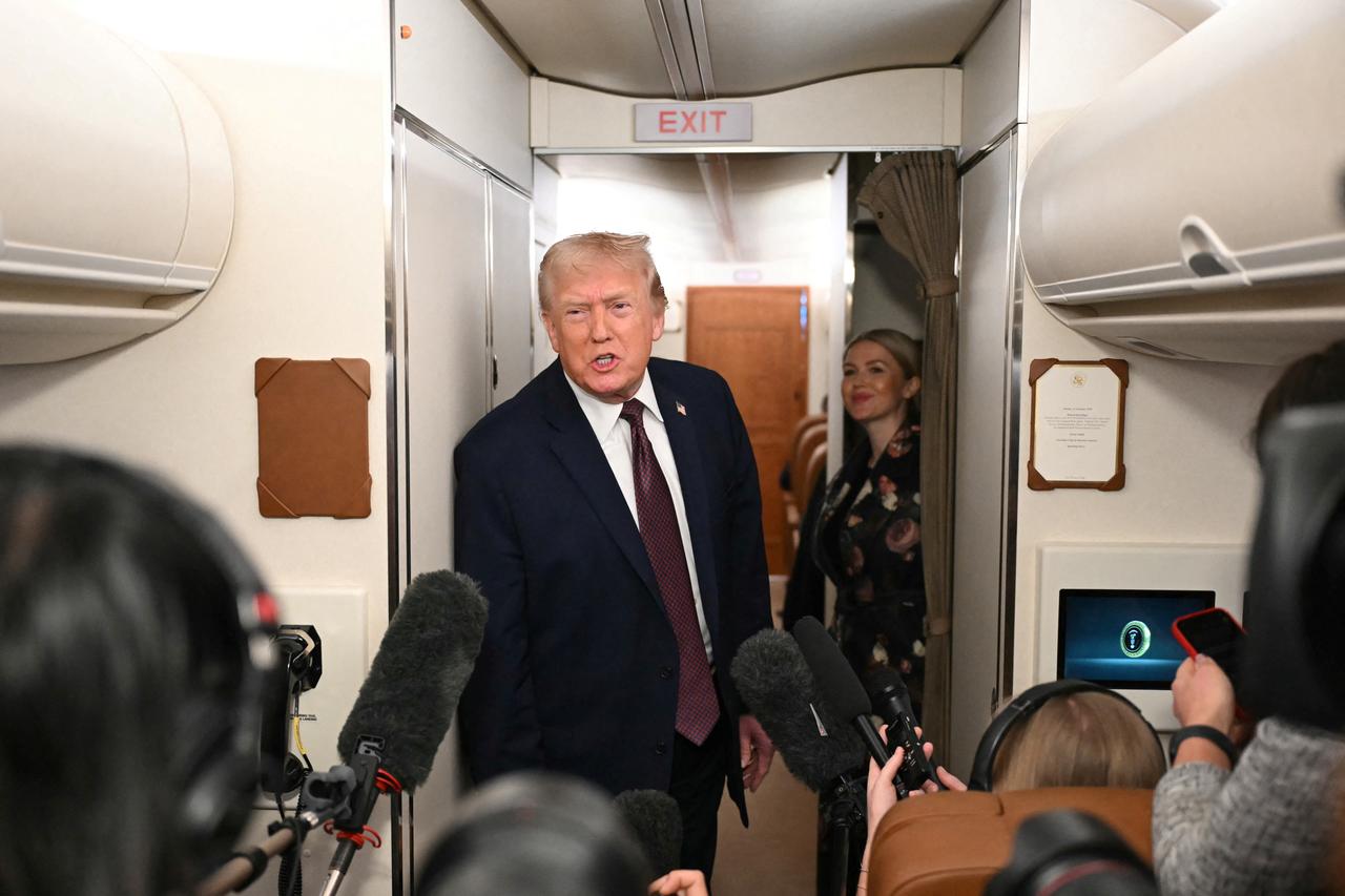 US President Donald Trump speaks to the press aboard Air Force One on January 11, 2026. (AFP Photo)