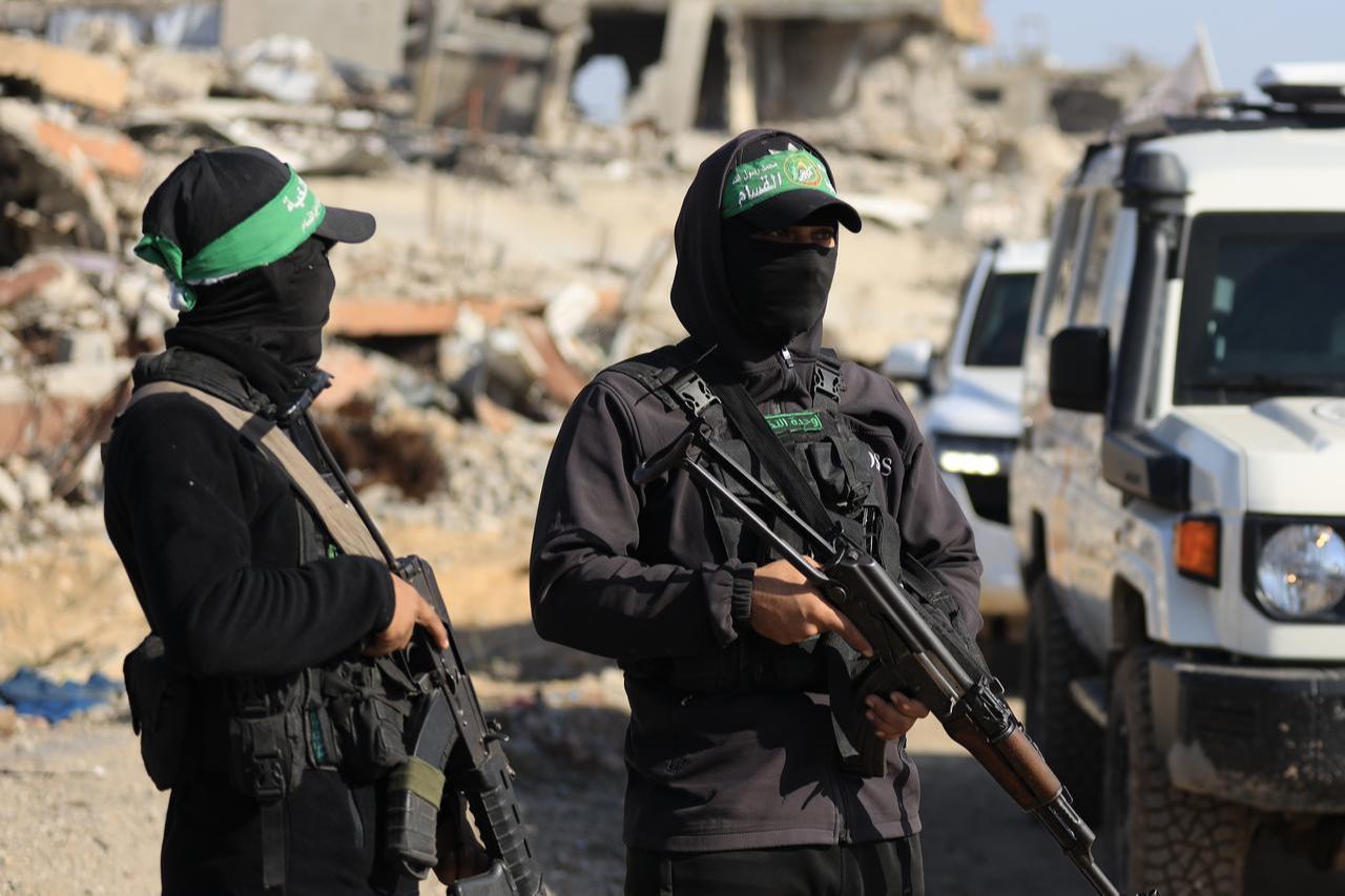 Hamas fighters stand guard in a heavily damaged area in Gaza, November 27, 2025. (AA Photo)