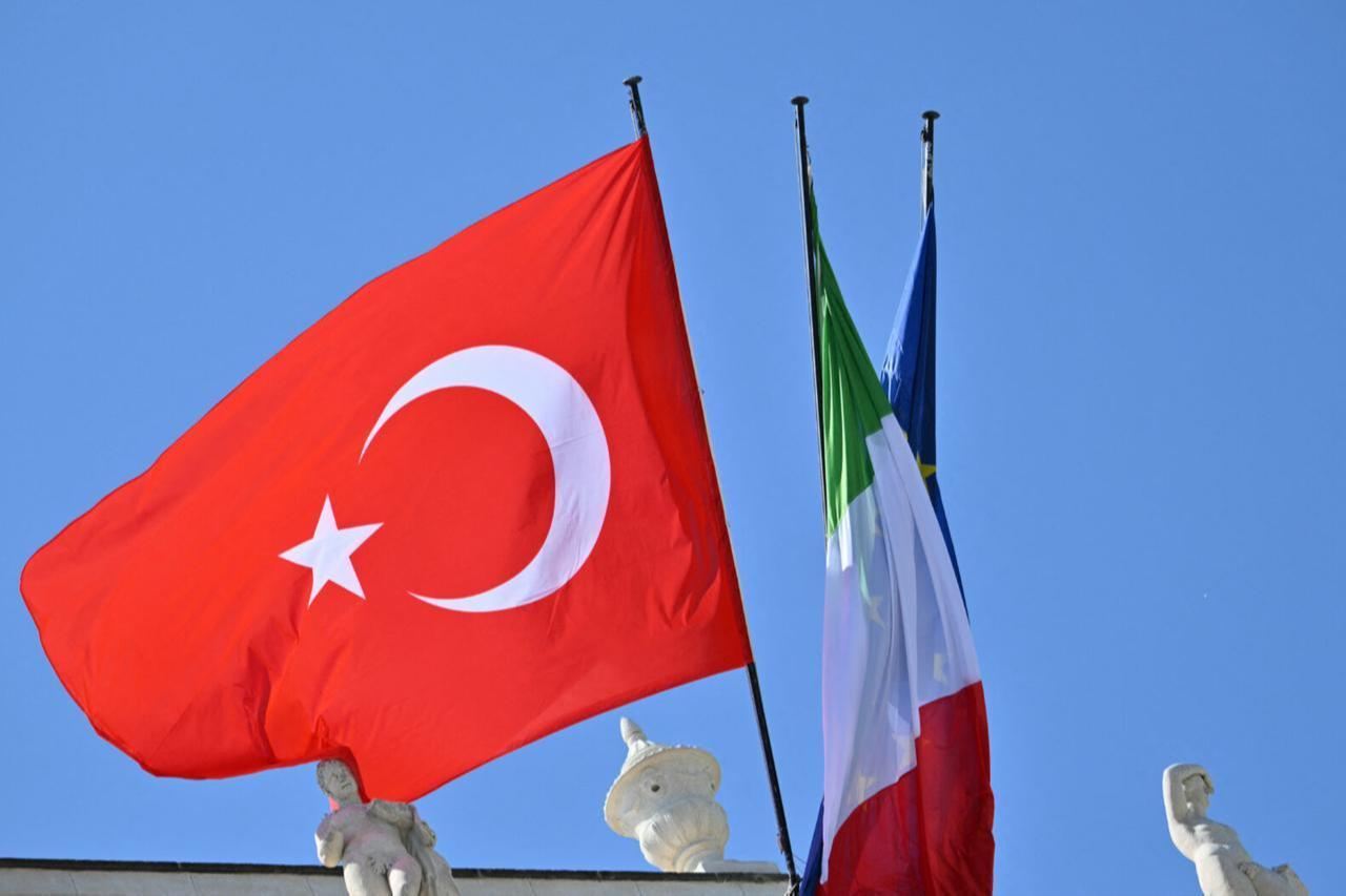 This photograph shows a fluttering Turkish flag next to the Italian and EU flags during a visit of President Erdogan at the Villa Doria Pamphili in Rome on April 29, 2025. (AFP Photo)