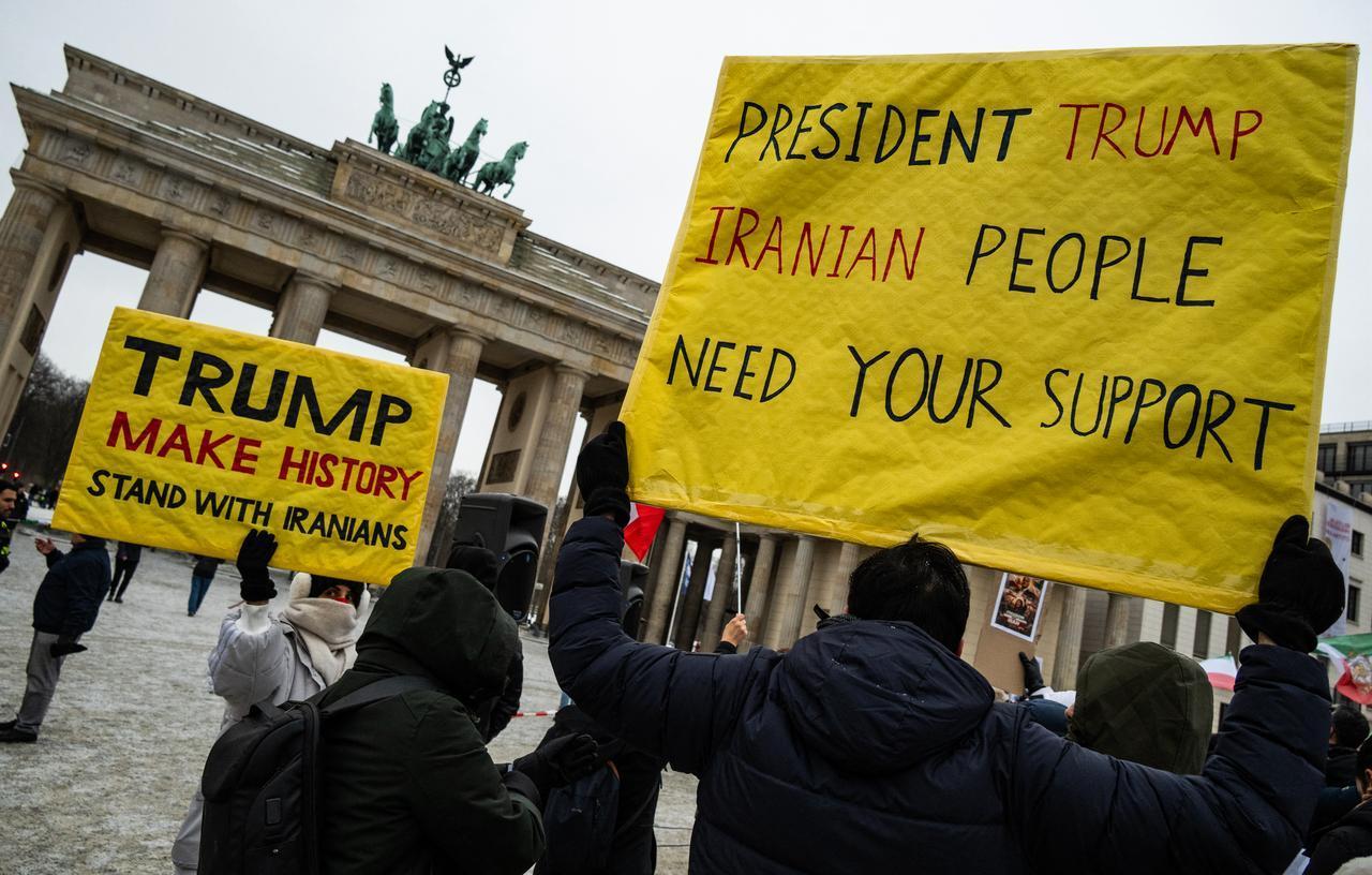 Demonstrators display placards calling for US President to intervene in Iran during an anti-Iranian-government protest in front of the Brandenburg Gate in Berlin, Germany, Jan. 12, 2026. (AFP Photo)