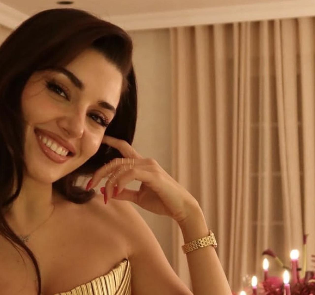 Hande Ercel smiles during a private New Year celebration at home, wearing a gold-toned outfit that drew widespread attention on social media, Jan. 1, 2026. (Photo via Instagram/@handemiyy)