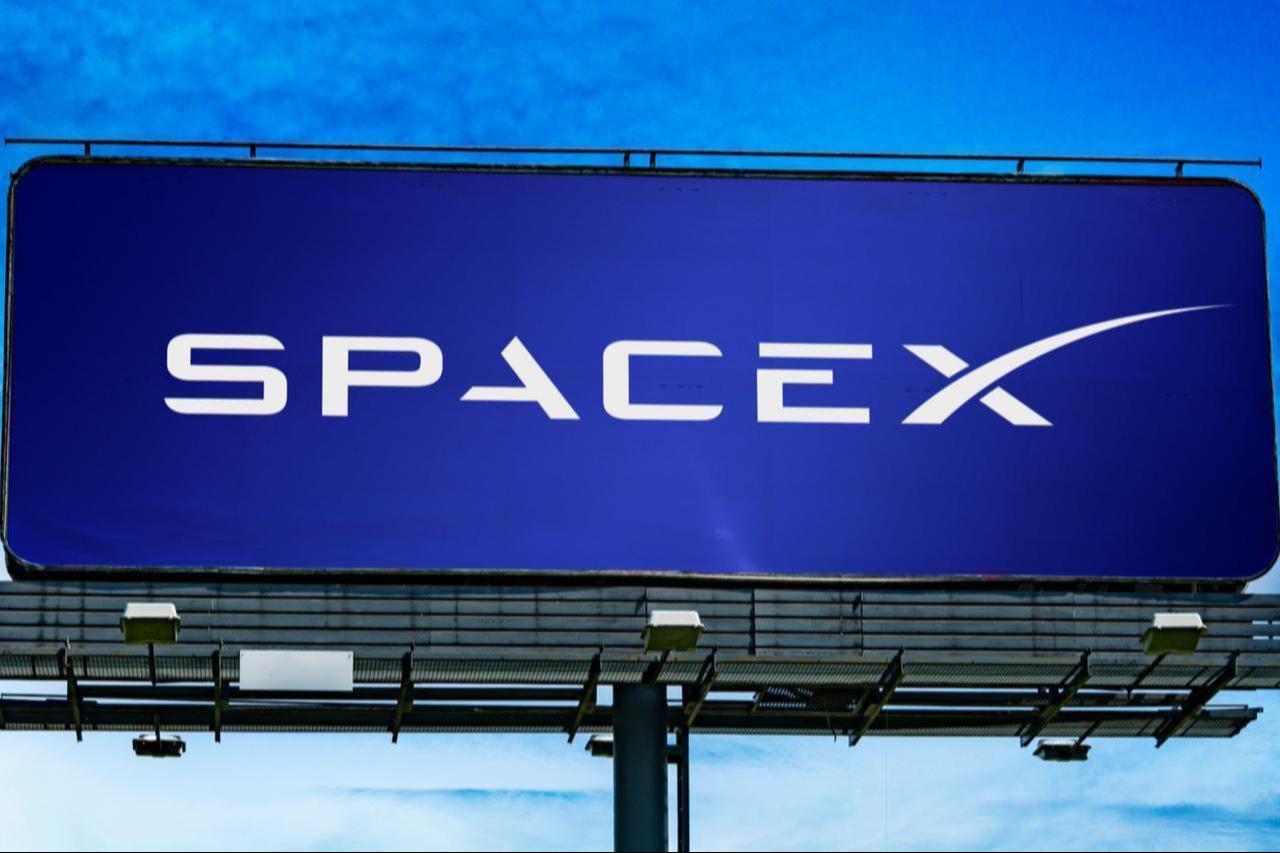 Advertisement billboard displaying logo of SpaceX, an American space technology company, date and time undisclosed. (Adobe Stock Photo)