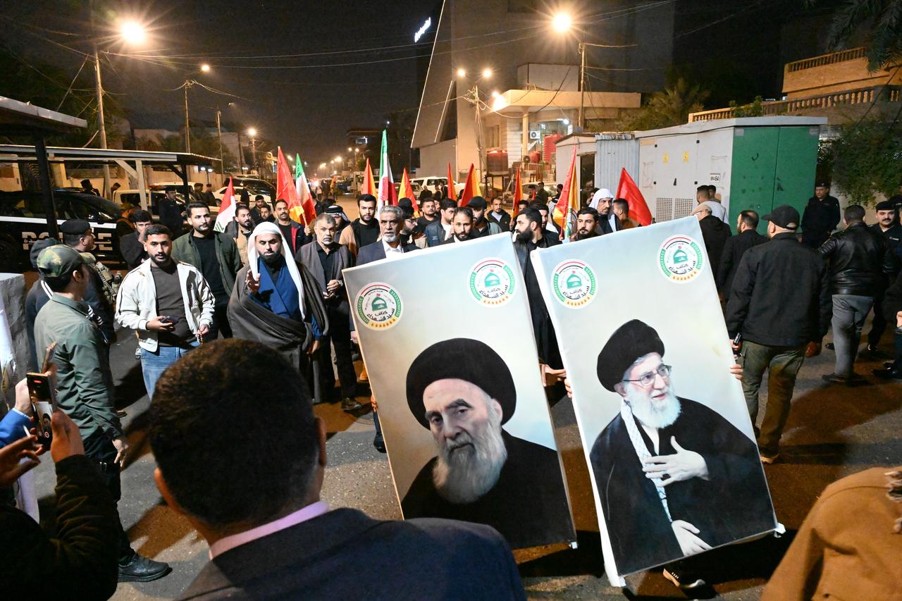 People, carrying posters of Shia cleric Ali al-Sistani and Iran’s Supreme Leader Ali Khamenei, gather in front of the Iranian Consulate General to protest against the anti-regime demonstrations that have been ongoing across Iran in recent days in Basra, Iraq on Jan. 13, 2026. (AA Photo)