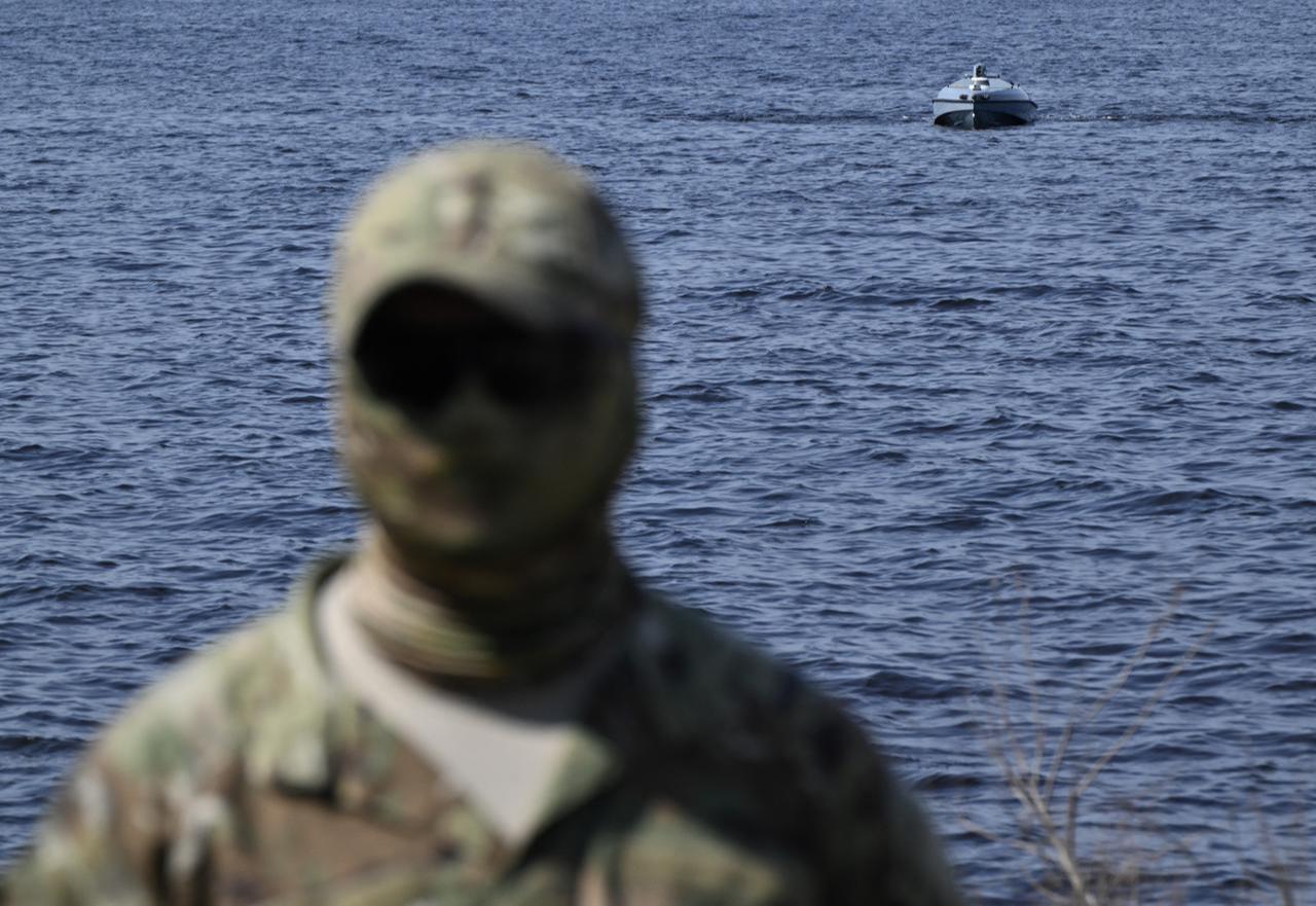 A Ukrainian serviceman of the Main Directorate of Intelligence of the Ministry of Defense of Ukraine stands in front of a naval drone Magura during a demonstration for journalists in an undisclosed location in Ukraine April 11, 2024. (AFP Photo)