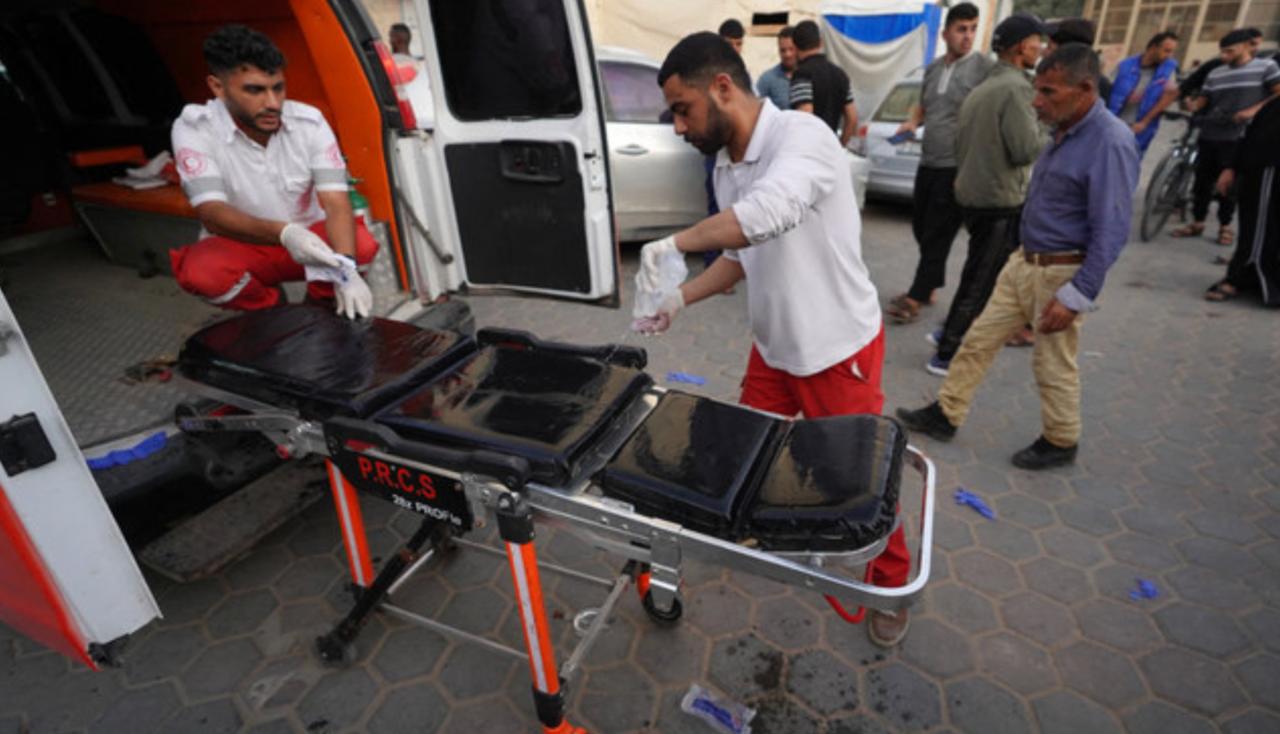 Palestinian medics prepare a stretcher beside an ambulance outside a hospital in Gaza ( AFP Photo )