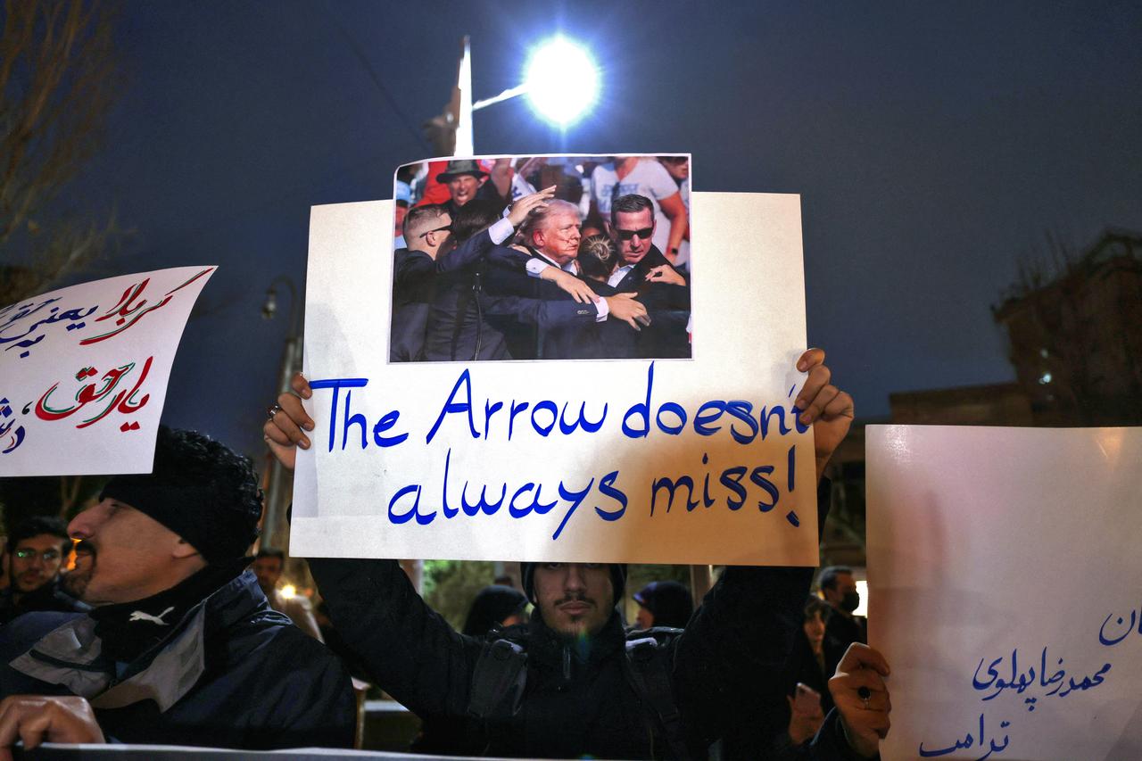 Members of the Basij volunteer Islamic militia hold placards during a protest in front of the British Embassy in Tehran, Iran on Jan. 14, 2026. (AFP Photo)