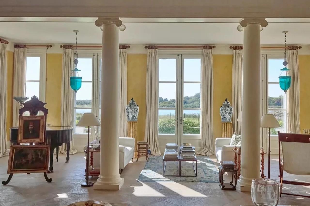 The main living room inside Ahmet and Mica Ertegun’s Southampton mansion with large windows overlooking the surrounding landscape, January 15, 2026. (Courtesy of Patronlar Dunyasi)