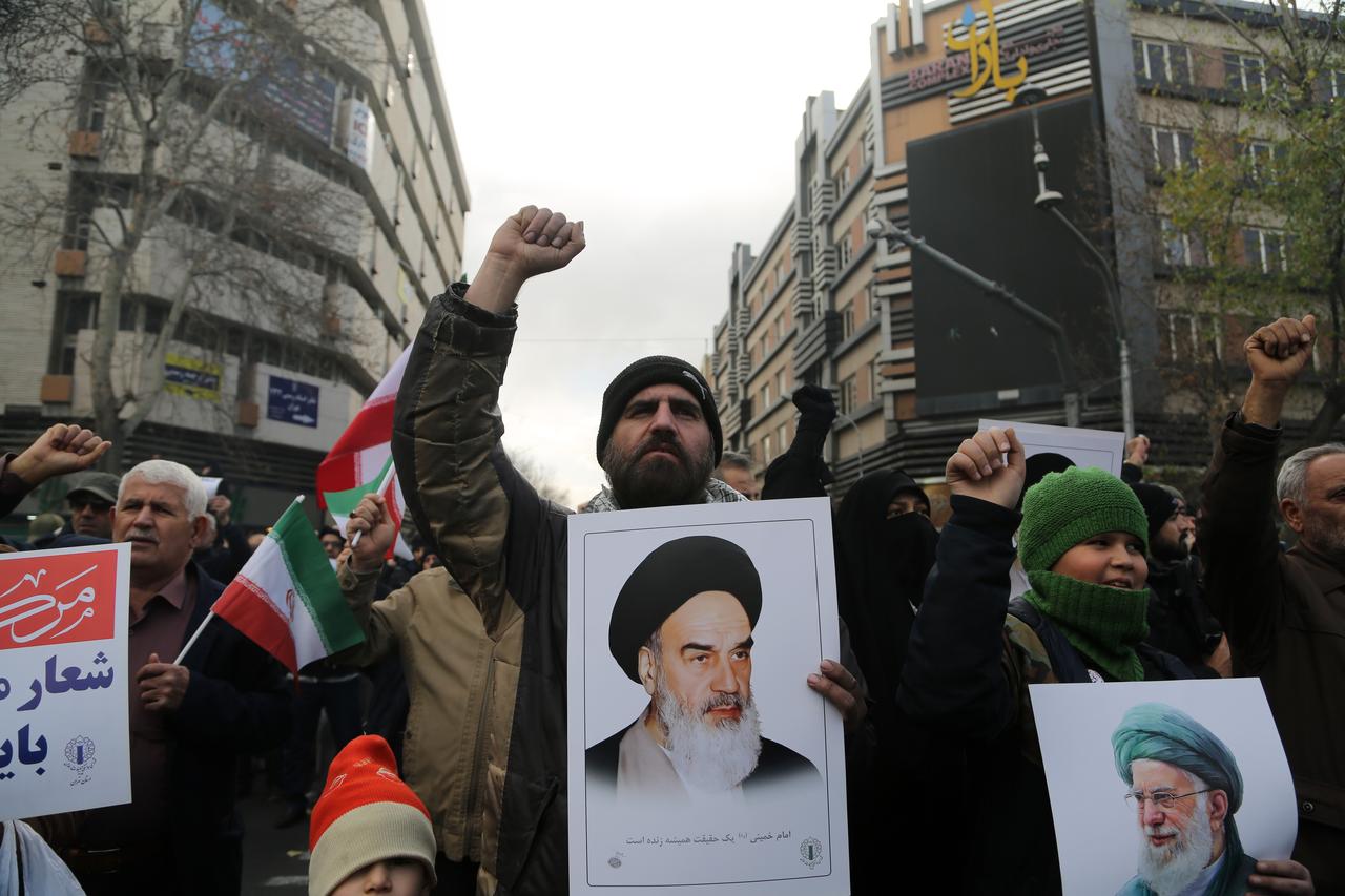 Thousands of people gather in front of Tehran University, carrying banners and chanting slogans against the United States and Israel, as a funeral ceremony is being held for 100 security personnel who lost their lives during the protests in Tehran, Iran, on Jan. 14, 2026. (AA Photo)