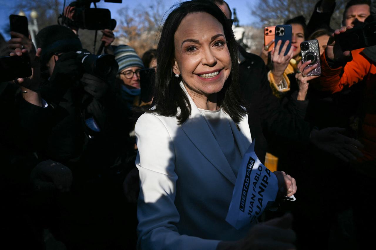 Venezuelan opposition leader Maria Corina Machado greets supporters outside the White House following a meeting with US President Donald Trump in Washington, DC, January 15, 2026. (AFP Photo)