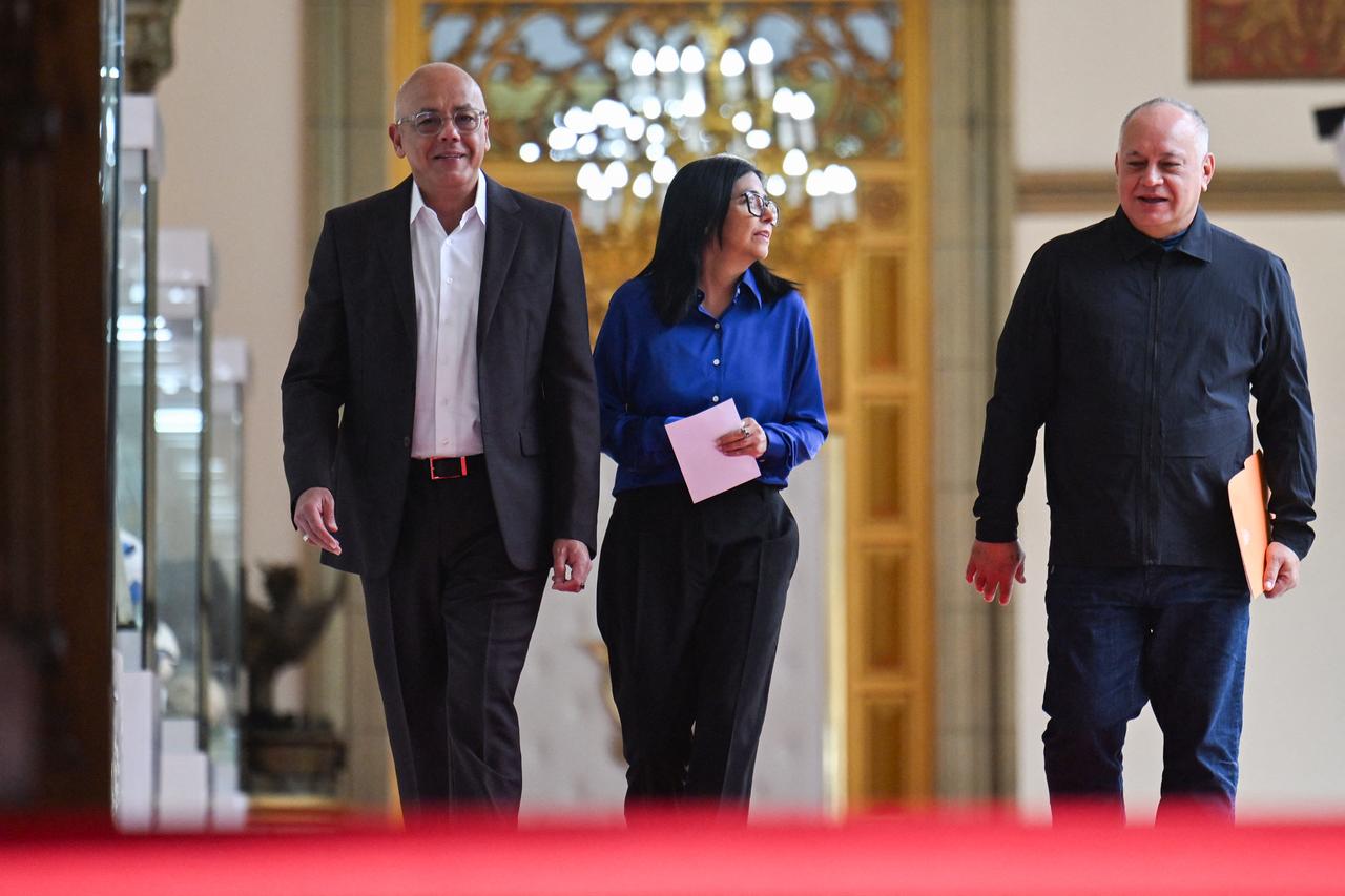 Venezuela's interim President Delcy Rodriguez (C), President of the National Assembly Jorge Rodriguez (L) and Minister of the Popular Power for Interior Diosdado Cabello walk ahead of a press conference at the Miraflores Presidential Palace in Caracas on Jan. 14, 2026. (AFP Photo)