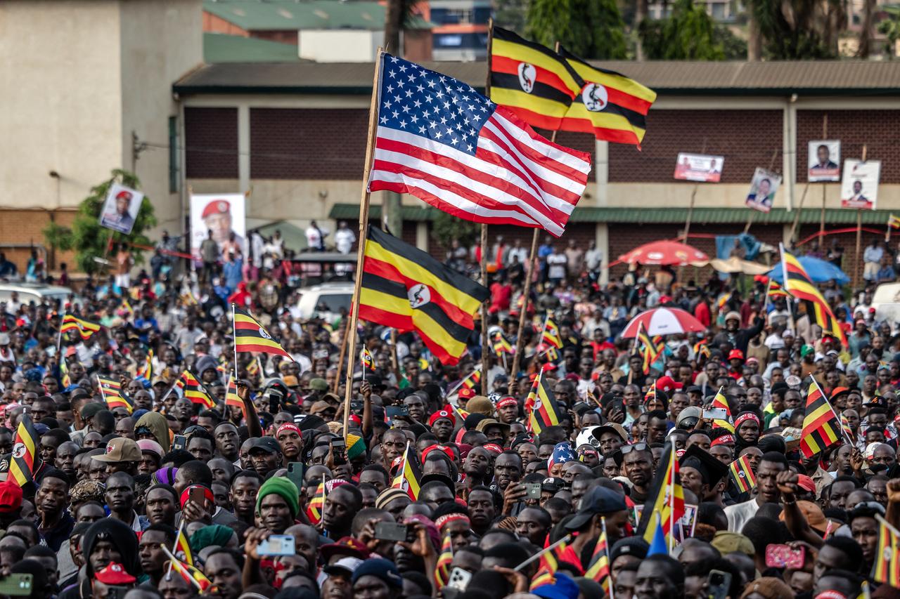 Supporters of opposition leader and presidential candidate for the National Unity Platform (NUP) Robert Kyagulanyi Ssentamu, popularly known as Bobi Wine, hold poles with Ugandan and US flags during the party’s final campaign rally ahead of the 2026 general elections, in Kampala on Jan. 12, 2026. (AFP Photo)