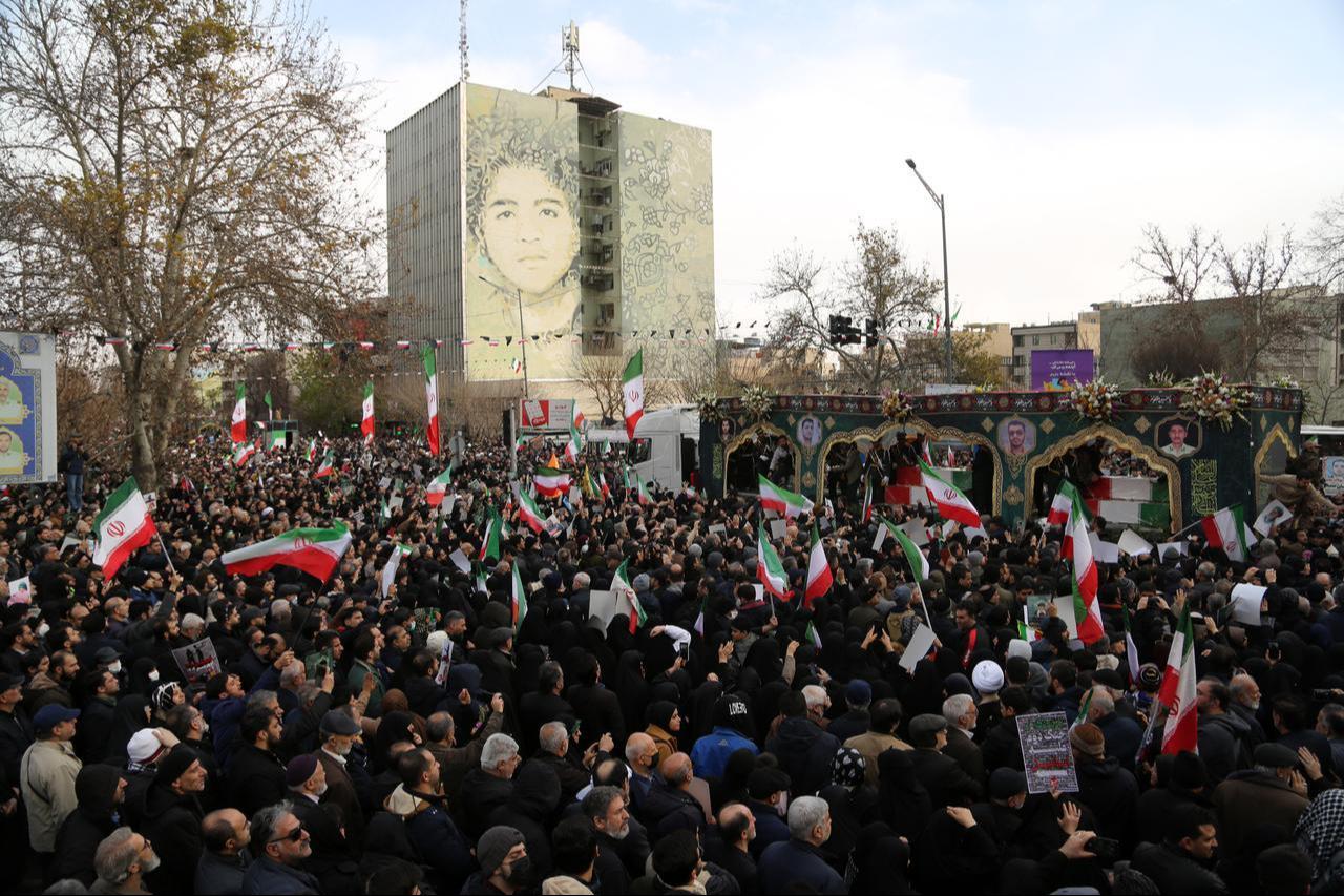 Thousands of people gather in front of Tehran University, carrying banners and chanting slogans against the United States and Israel, as a funeral ceremony is being held for 100 security personnel who lost their lives during the protests in Tehran, Iran, on Jan. 14, 2026. (AA Photo)