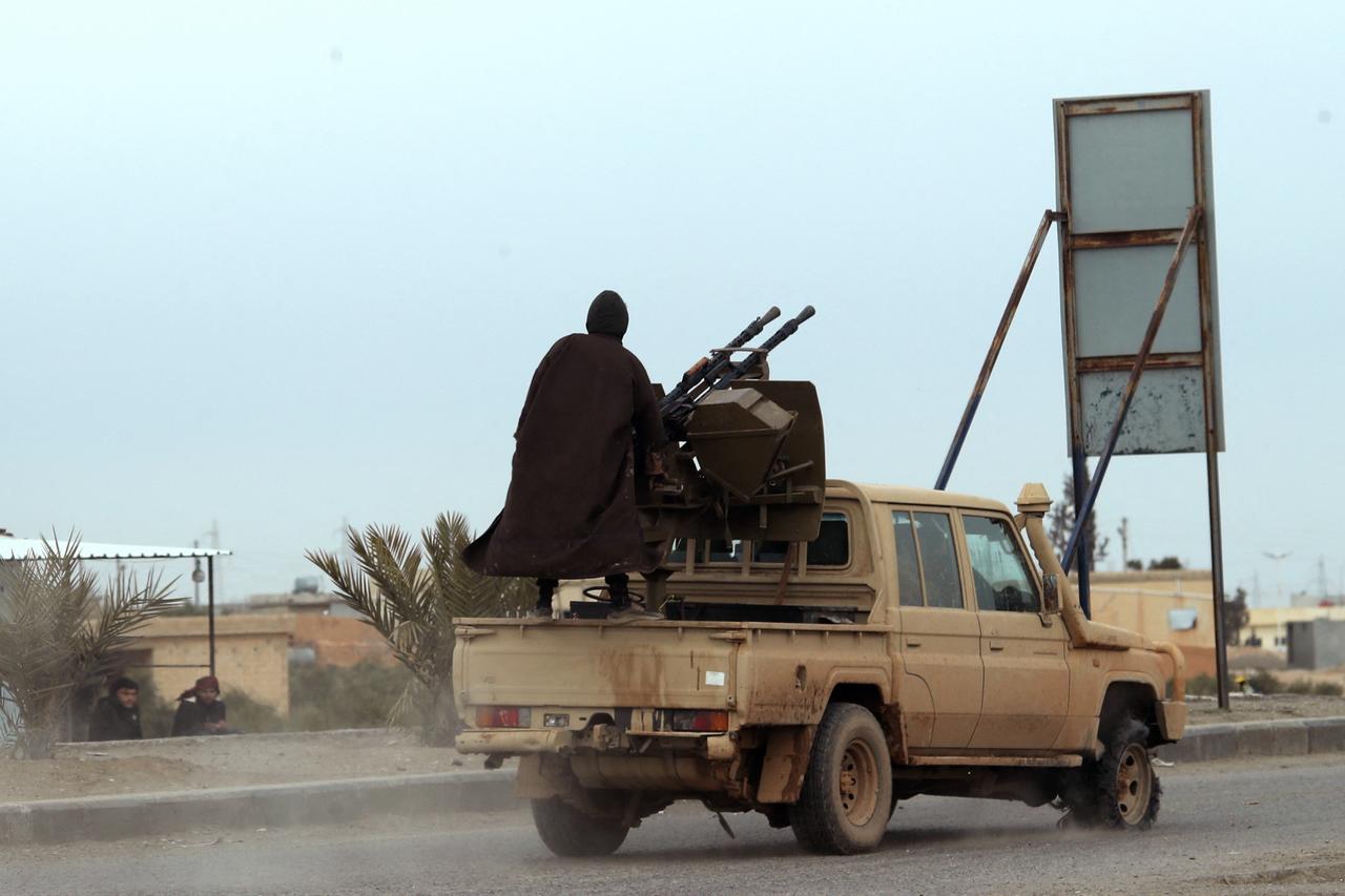 Members of the terrorist organization YPG-led SDF in a pick-up truck are seen at the entrance to the city of Tabqa in the northern Syrian Raqa province, on January 17, 2026. (AFP Photo)