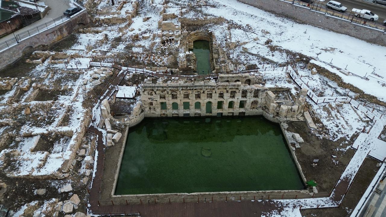 An aerial view shows the Basilica Therma Roman Bath complex surrounded by light snowfall, revealing its pools and archaeological remains in the Sarikaya district of Yozgat, central Türkiye. (AA Photo)