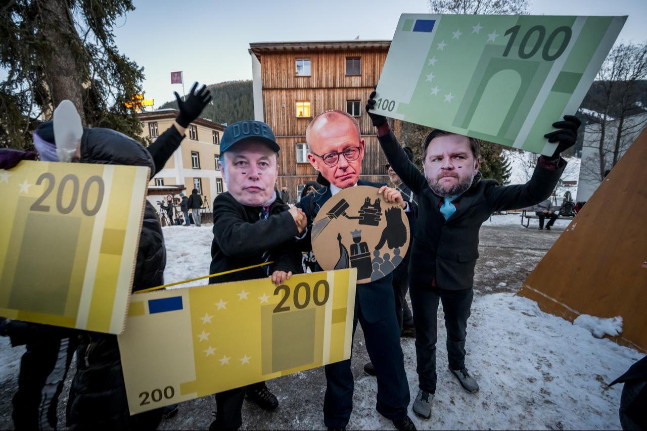 Protesters wearing a mask of Tesla CEO Elon Musk, Germany's Chancellor Friedrich Merz and US Vice President JD Vance hold cardboard cut-out euro banknotes in Davos, January 18, 2026. (AFP Photo)
