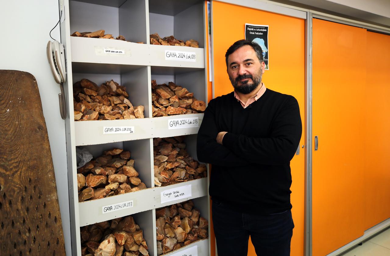 Professor Ismail Baykara stands next to shelves filled with catalogued stone artifacts collected during Ice Age surveys in Gaziantep, Türkiye, Jan. 2025. (AA Photo)