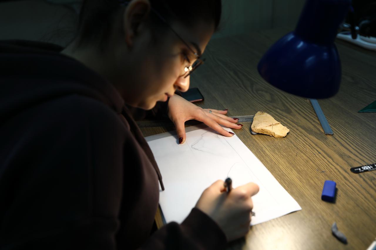 An archaeologist documents a prehistoric stone tool during laboratory analysis as part of Gaziantep University’s Pleistocene surface survey, Gaziantep, Türkiye, Jan. 2025. (AA Photo)