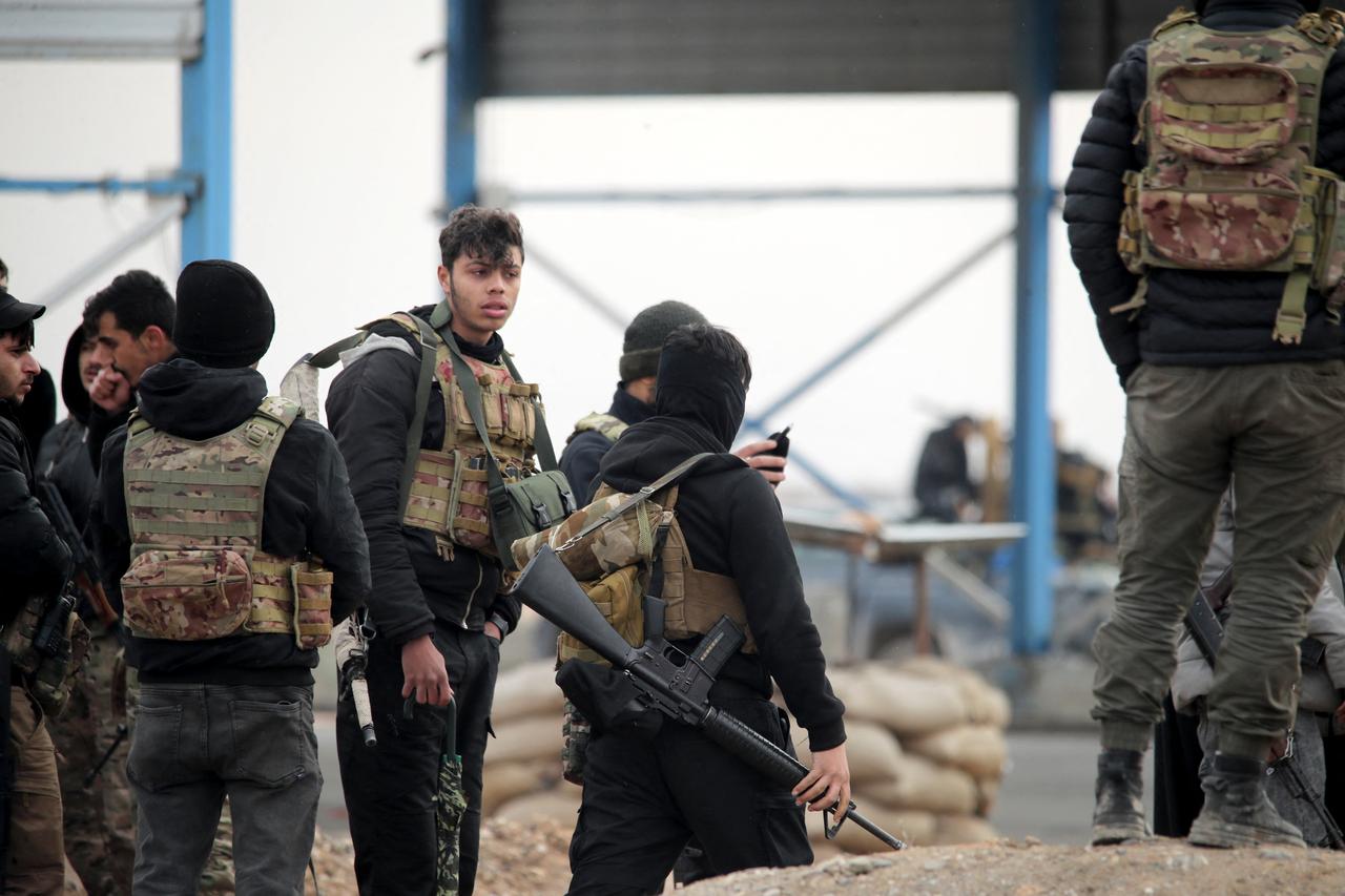 Terrorist organization YPG/SDF members at the entrance to the city of Tabqa, in the northern Syrian Raqqa province, January 17, 2026. (AFP Photo)