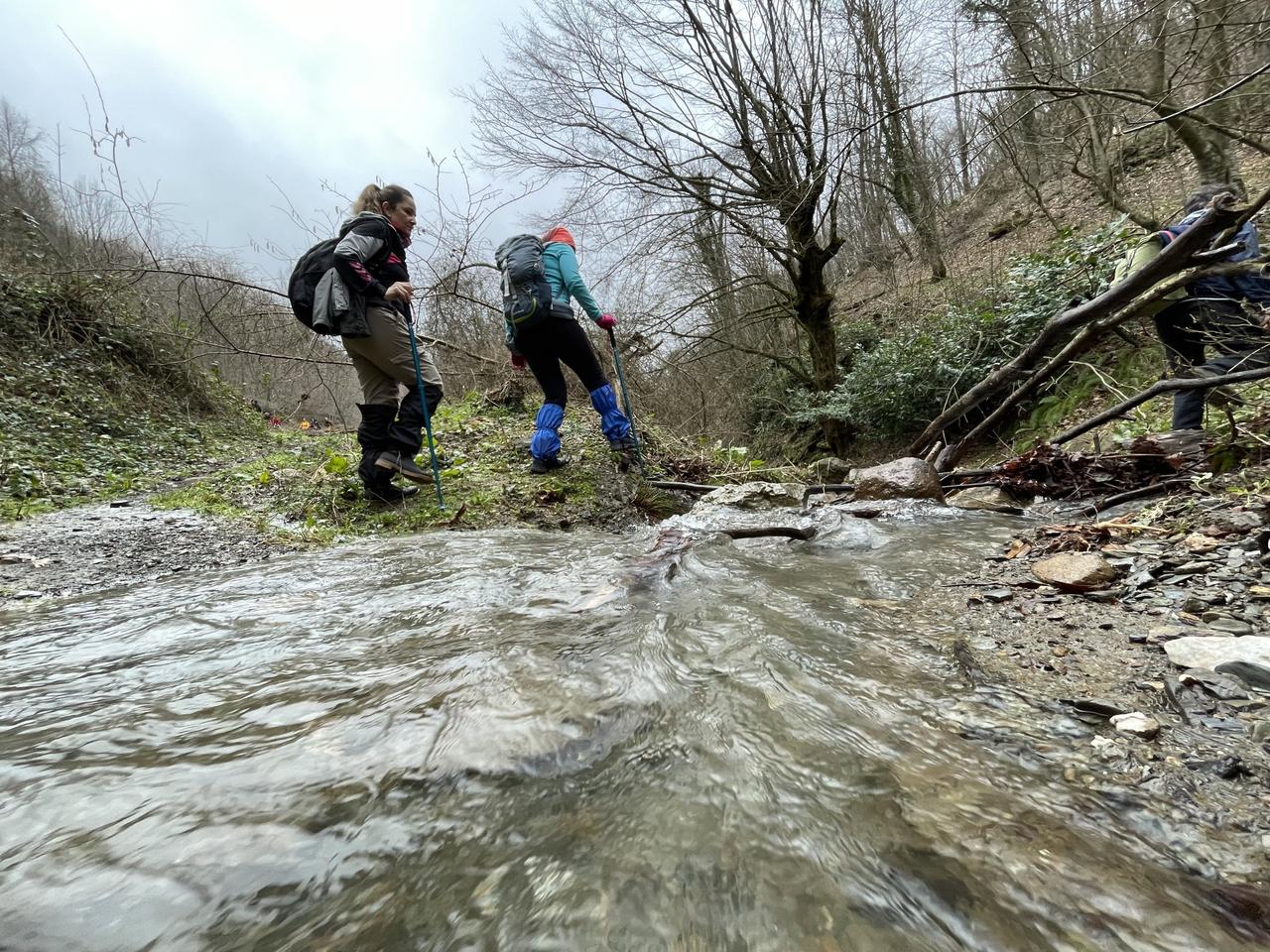 Trekkers crossing a stream along the 16-kilometer Kurtkoy-Guneykoy part of the 801-kilometer "Sufi Trail" that stretches from Istanbul to Konya in central Türkiye and takes 40 days to complete, Feb. 13, 2022. (AA Photo)