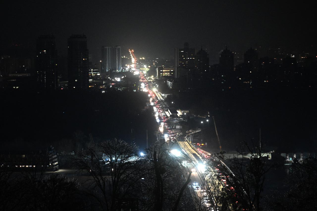 Cars drive along a road during a power outage in Kyiv on Jan. 20, 2026. (AFP Photo)