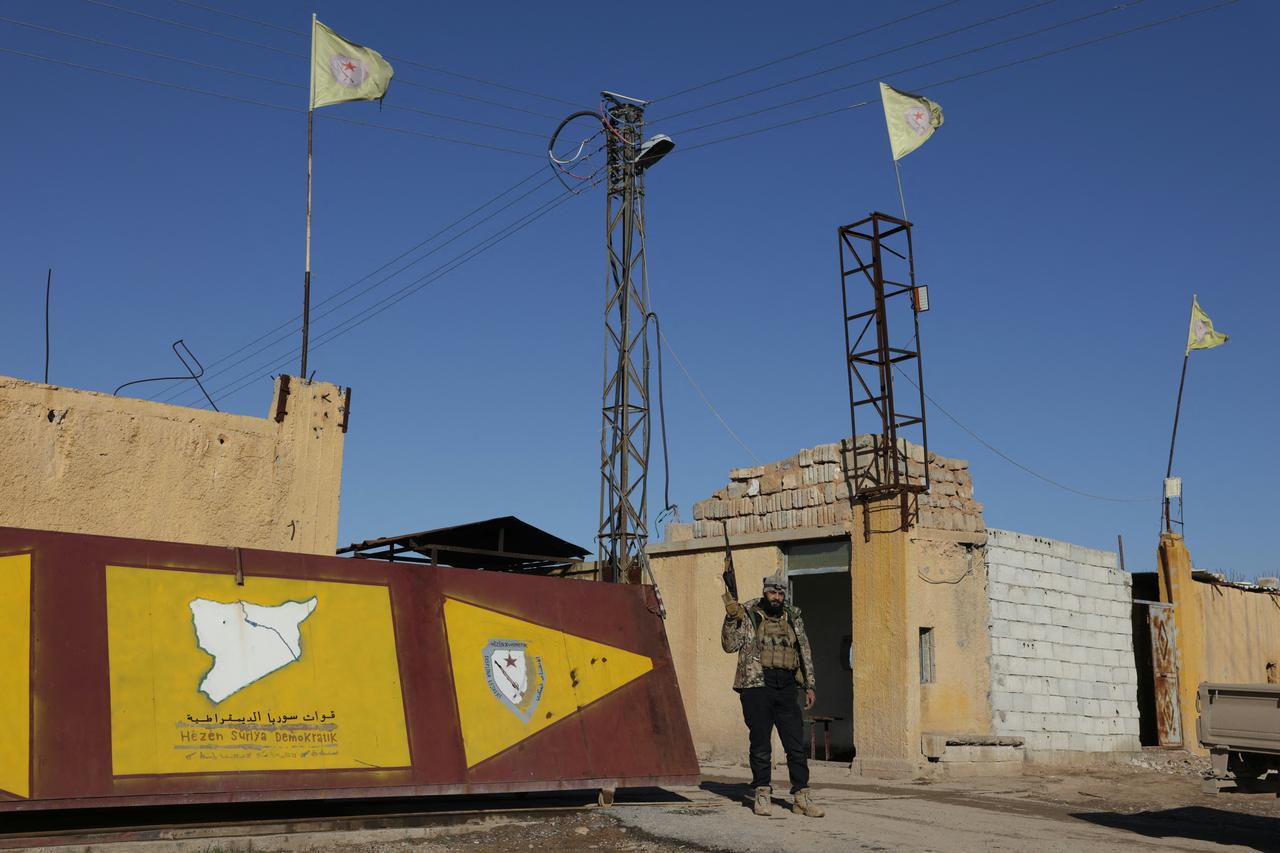 A member of the Syrian government forces brandish a weapon as they take possession of the SDF military base as they enter the city of Raqqa, Syria, January 19, 2026. (AFP Photo)