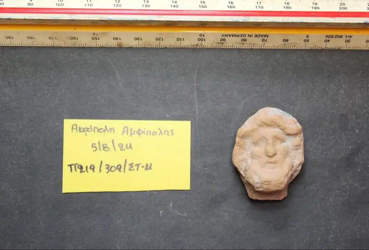 A small terracotta relief head of Asklepios found at the Amphipolis Acropolis, one of the key discoveries supporting the interpretation of the site as a cult area.  (Photo via AMNA)