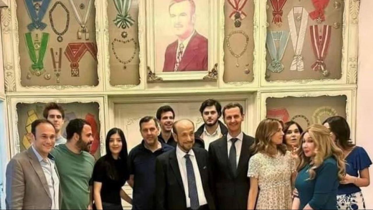 A photo shows Rifaat al-Assad alongside former Syrian President Bashar al-Assad and his brother Maher, as well as other relatives from the Assad family ( Photo via fanack )