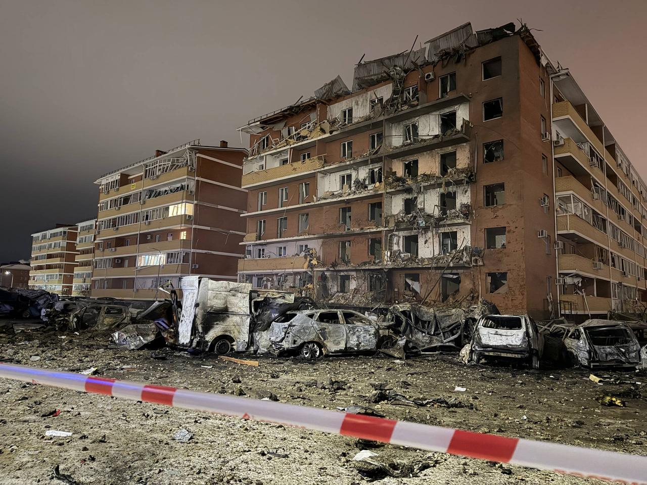 This handout picture posted on January 21, 2026 on the official Telegram account of Murat Kumpilov, the head of Russia's Adygea Republic, shows a damaged residential building and parking lot following a drone attack in the republic's Takhtamukaysky district. (AFP Photo / Telegram / muratkumpilov Handout)