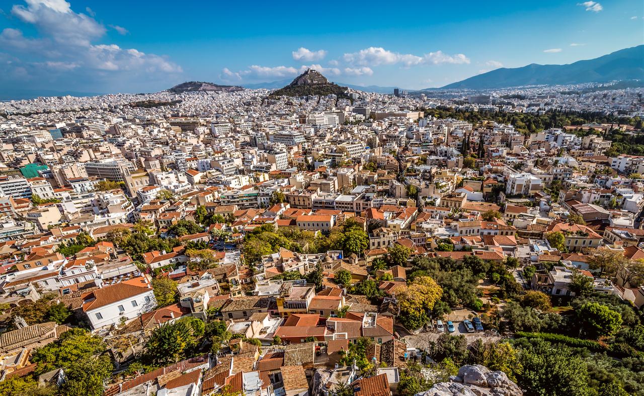 Panoramic view of Athens from the Acropolis, overlooking the historic city center with Lycabettus Mountain in the distance, Greece. (Adobe Stock Photo)