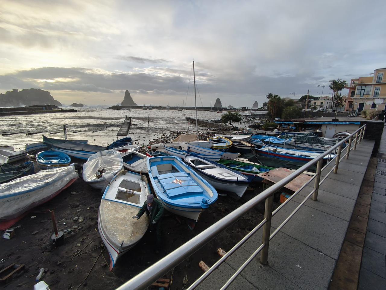 Small fishing boats are piled up along the waterfront after being torn from their moorings by rough seas and sustained wave action. (Photo via palermo.gds.it)