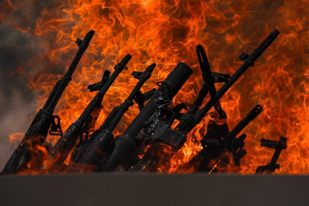 The first group of PKK militants lays down and destroys their weapons in Sulaimaniyah, northern Iraq, on July 11, 2025. (AA Photo)
